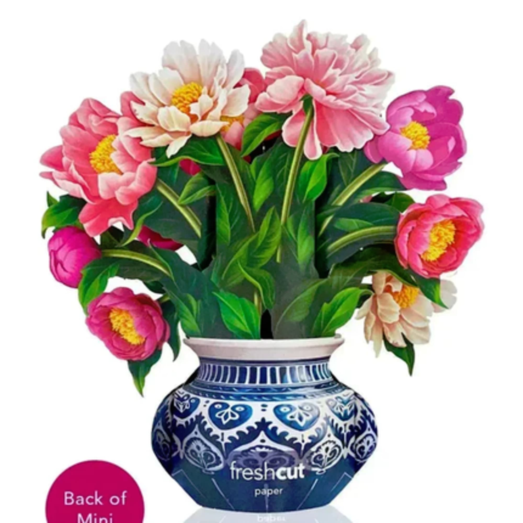 Pink and white flowers in a blue patterned vase