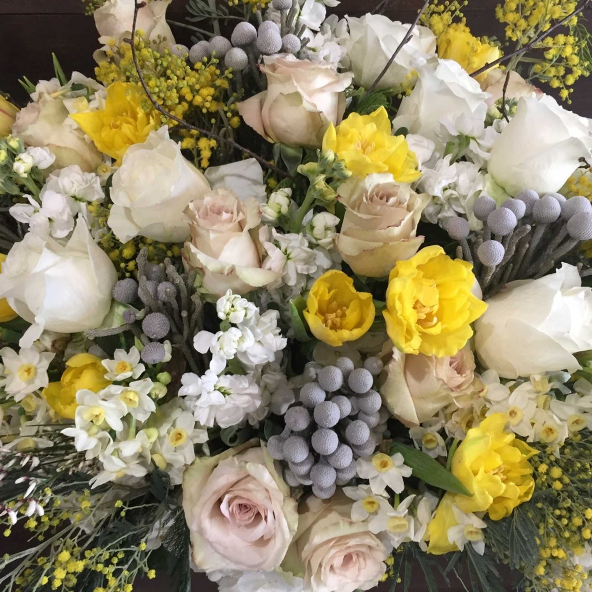 Bouquet of white and pale pink roses with yellow flowers