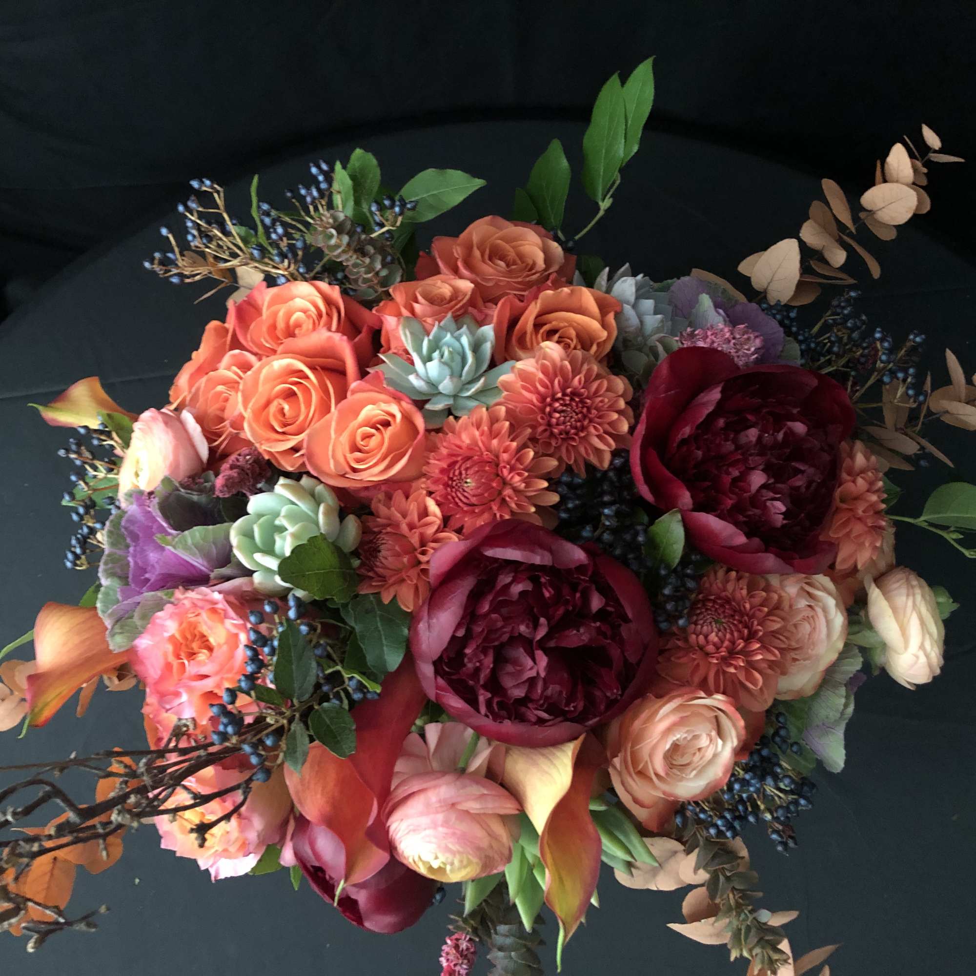 Mixed bouquet with coral roses, burgundy peonies, and calla lilies