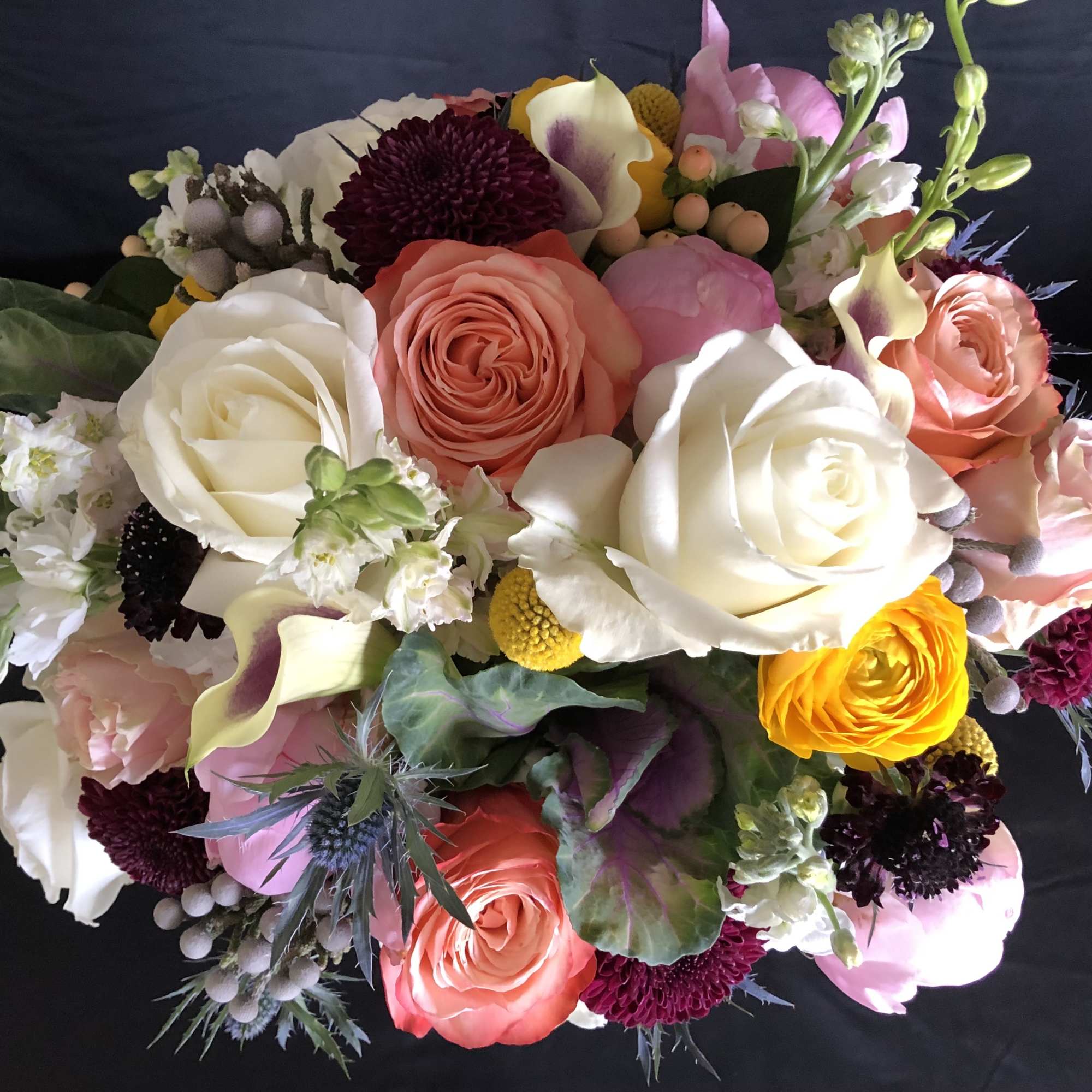 Mixed bouquet of roses, calla lilies, and chrysanthemums in pink, white, and yellow