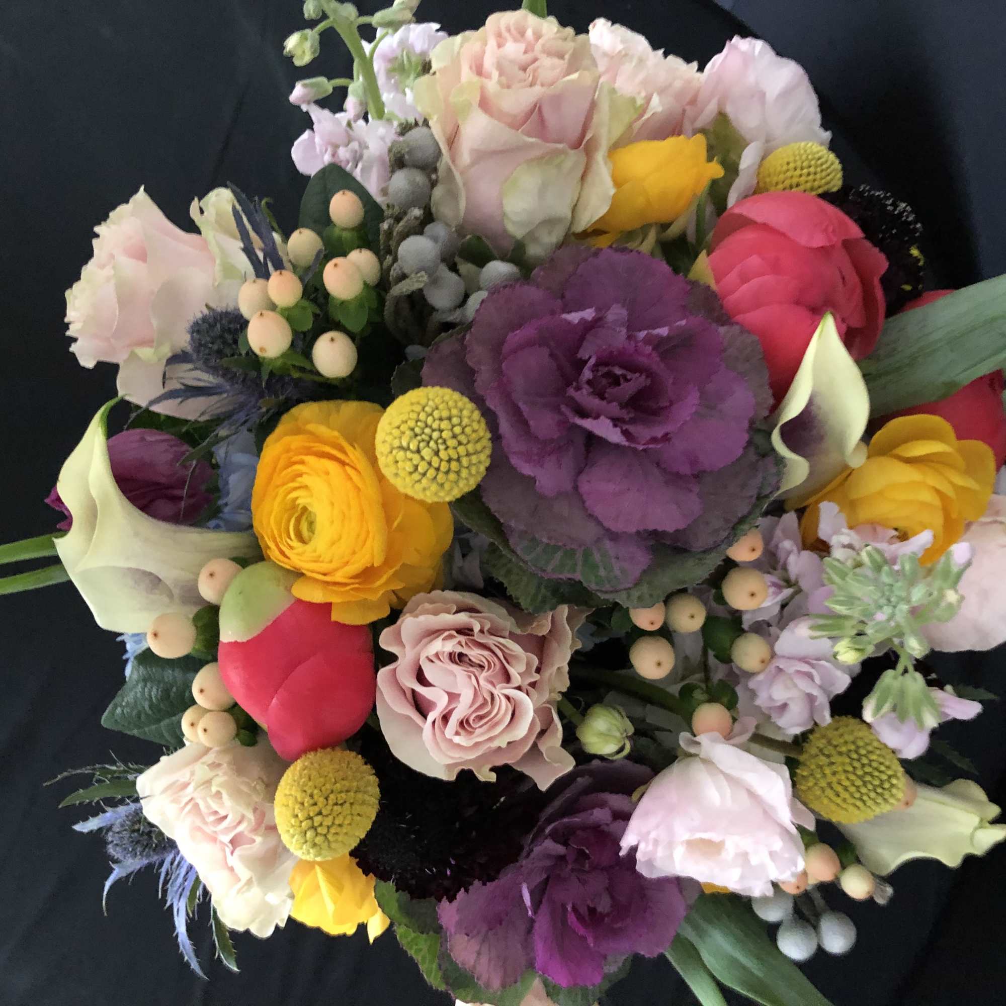 Colorful mixed bouquet with roses, calla lilies, and purple cabbage flowers