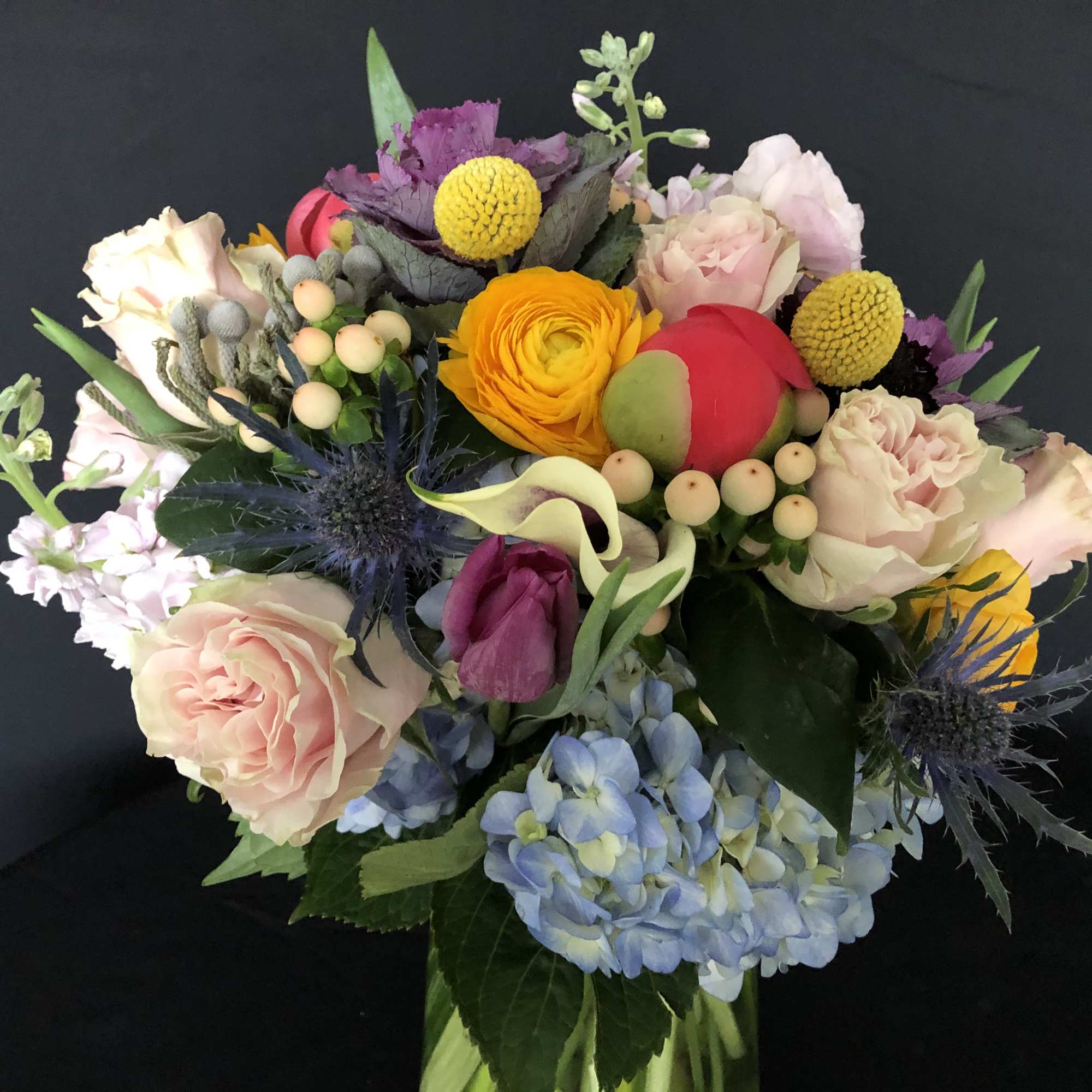 Mixed bouquet with roses, hydrangea, and bright accent flowers
