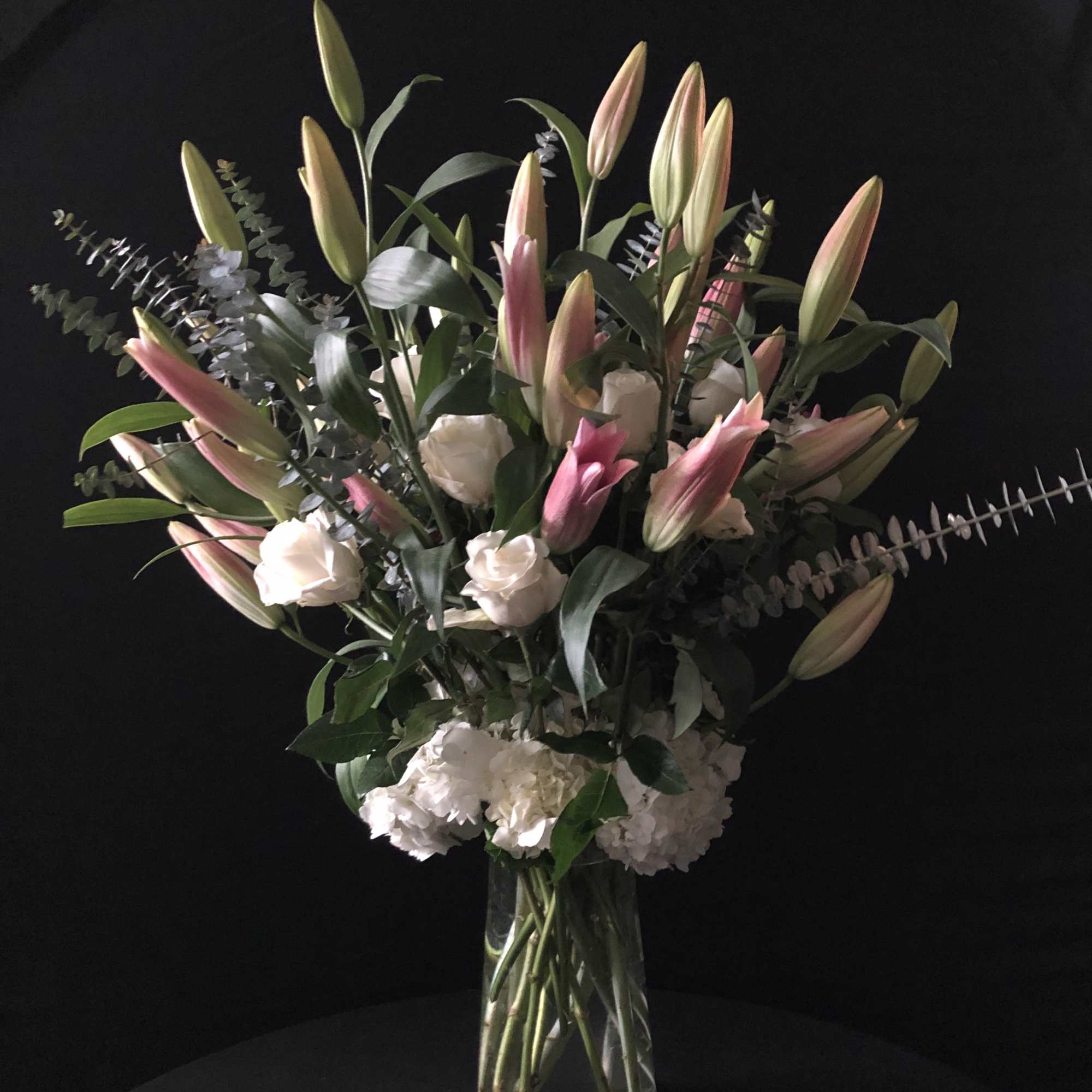 This tall arrangements is composed of white hydrangeas, roses and lilies.



We will