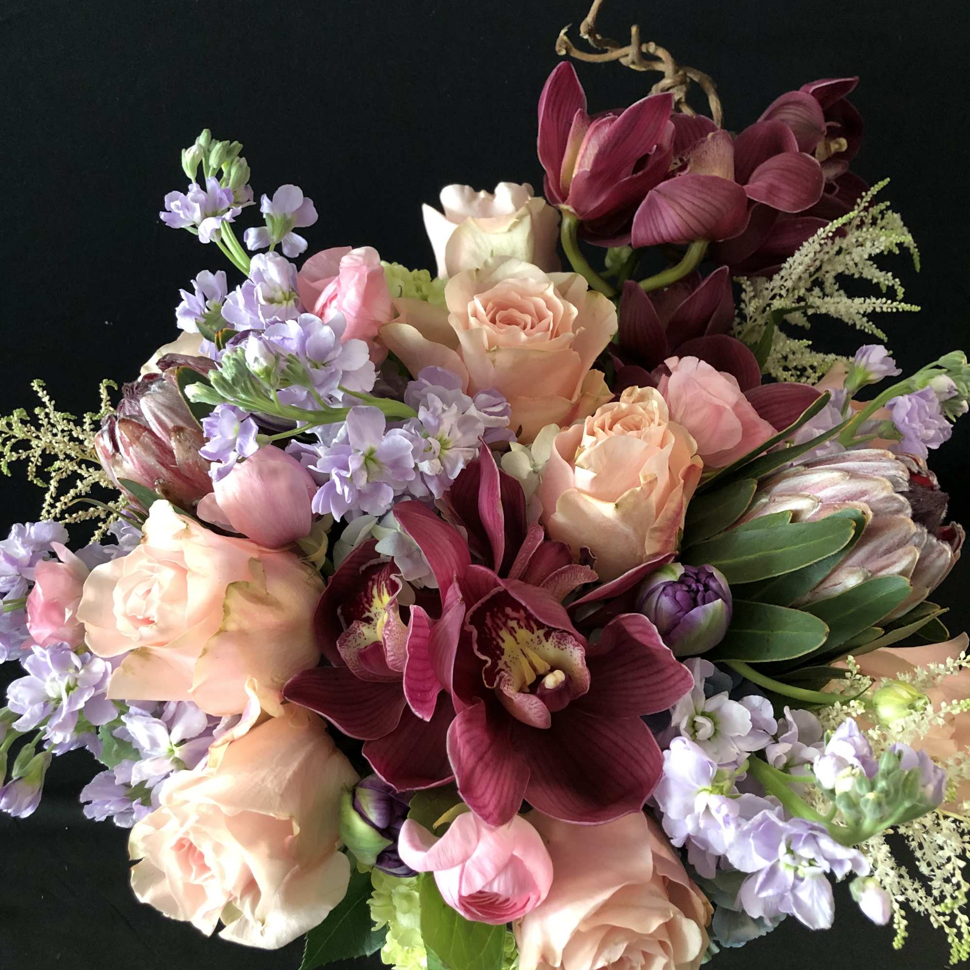 Bouquet of peach roses, burgundy orchids, and lavender flowers, photo 16 of 19