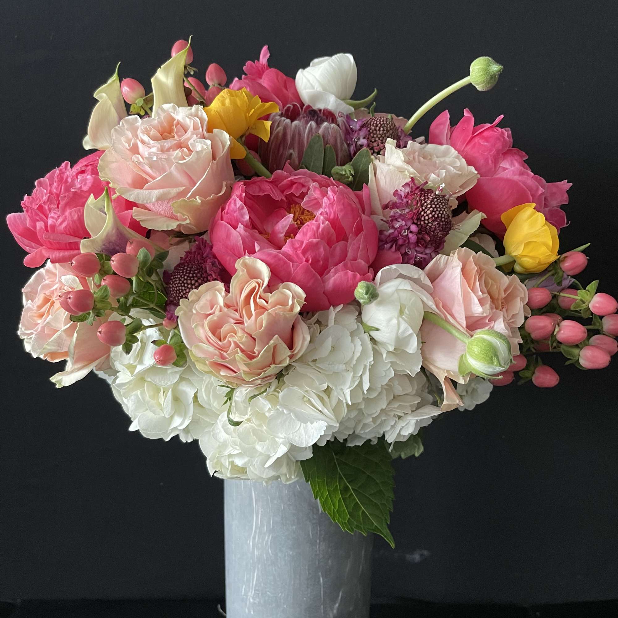 Pink and white mixed bouquet in a tall silver vase