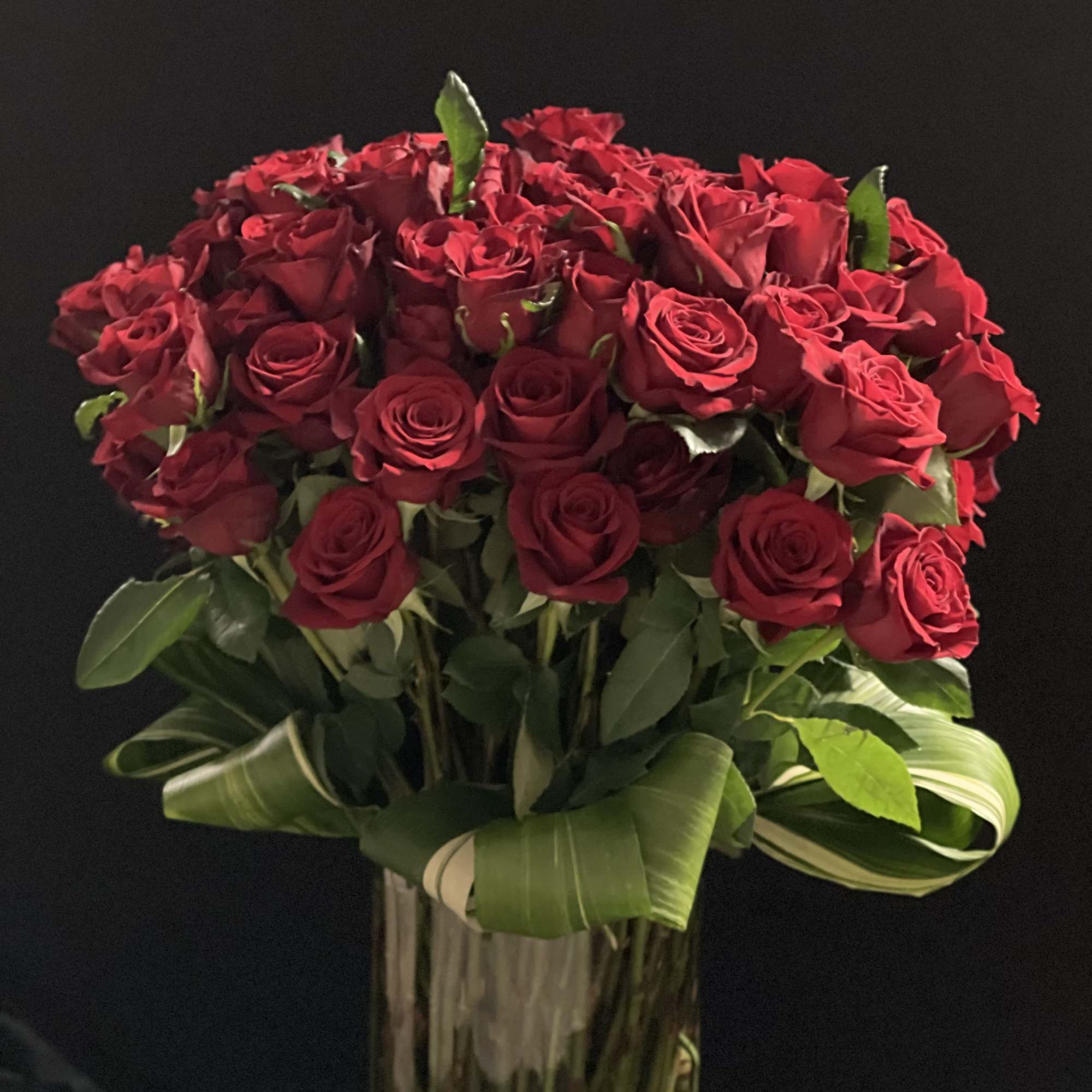 Bouquet of red roses in a tall glass vase, photo 9 of 9
