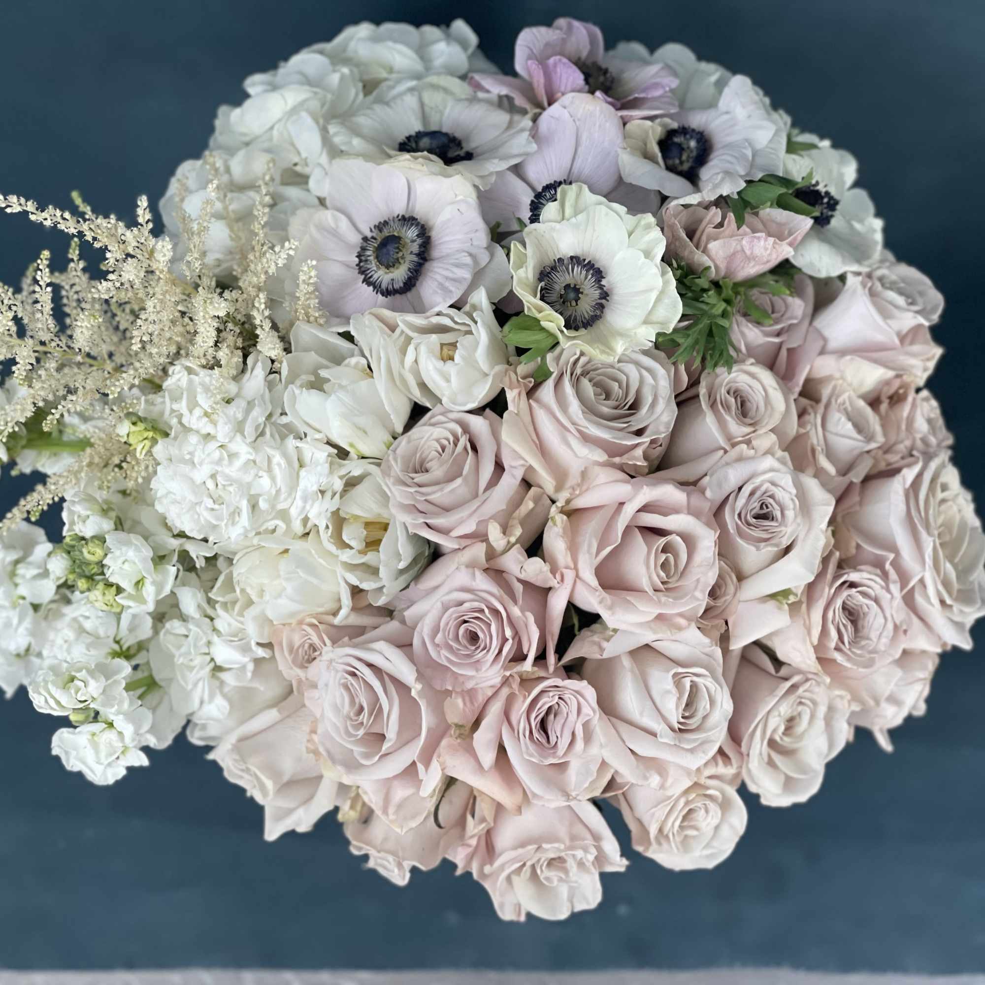 Bouquet of pale pink roses and white anemones with white filler flowers