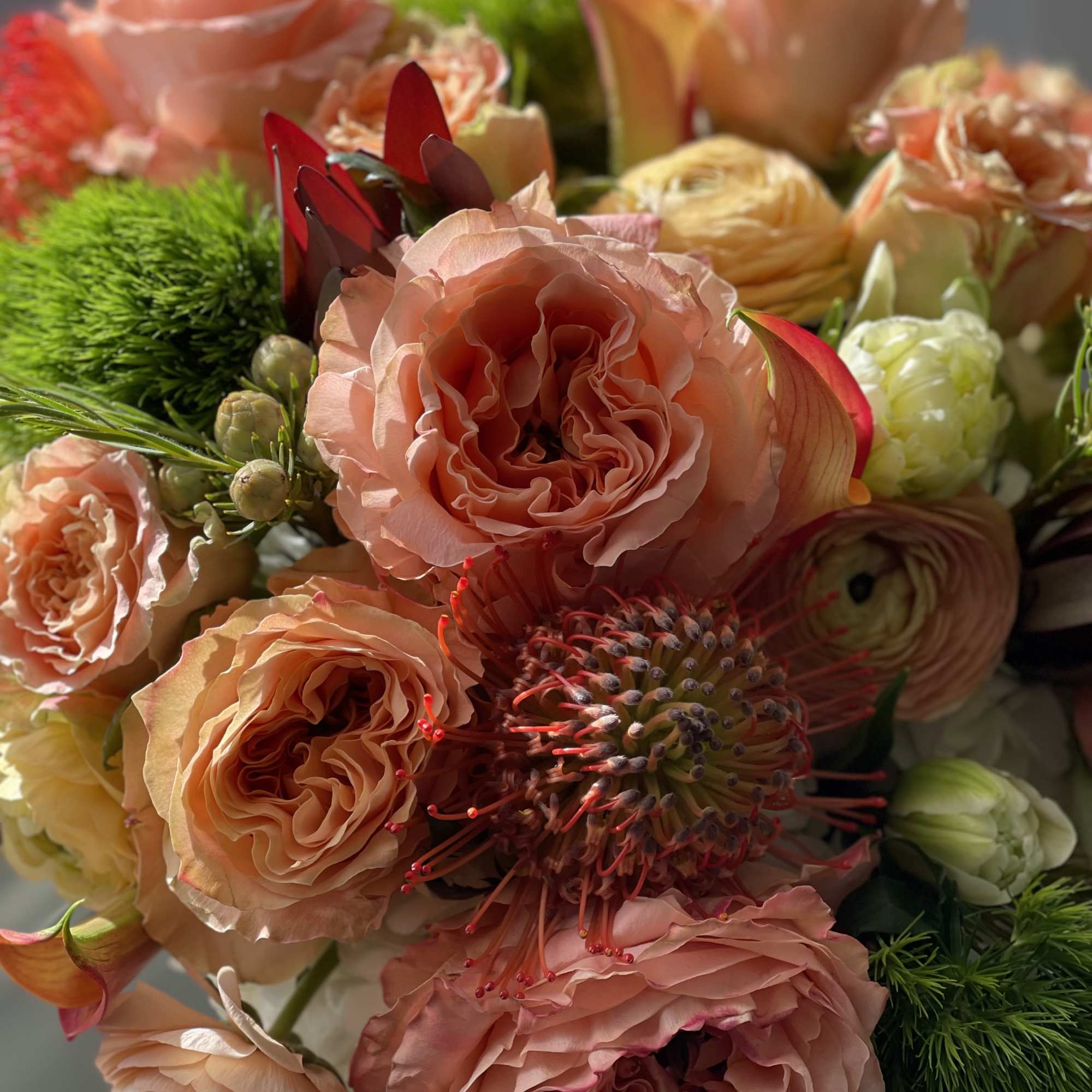 Peach and blush bouquet with roses and pincushion protea