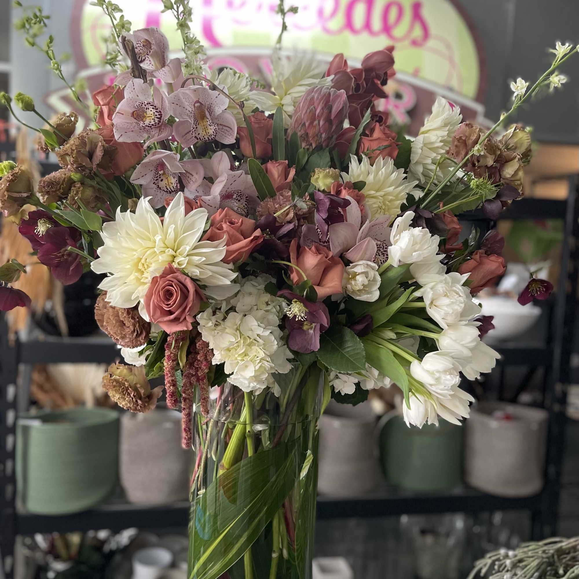 Filled with dahlias, orchids, protea, hydrangeas, tulips and roses, this design is
