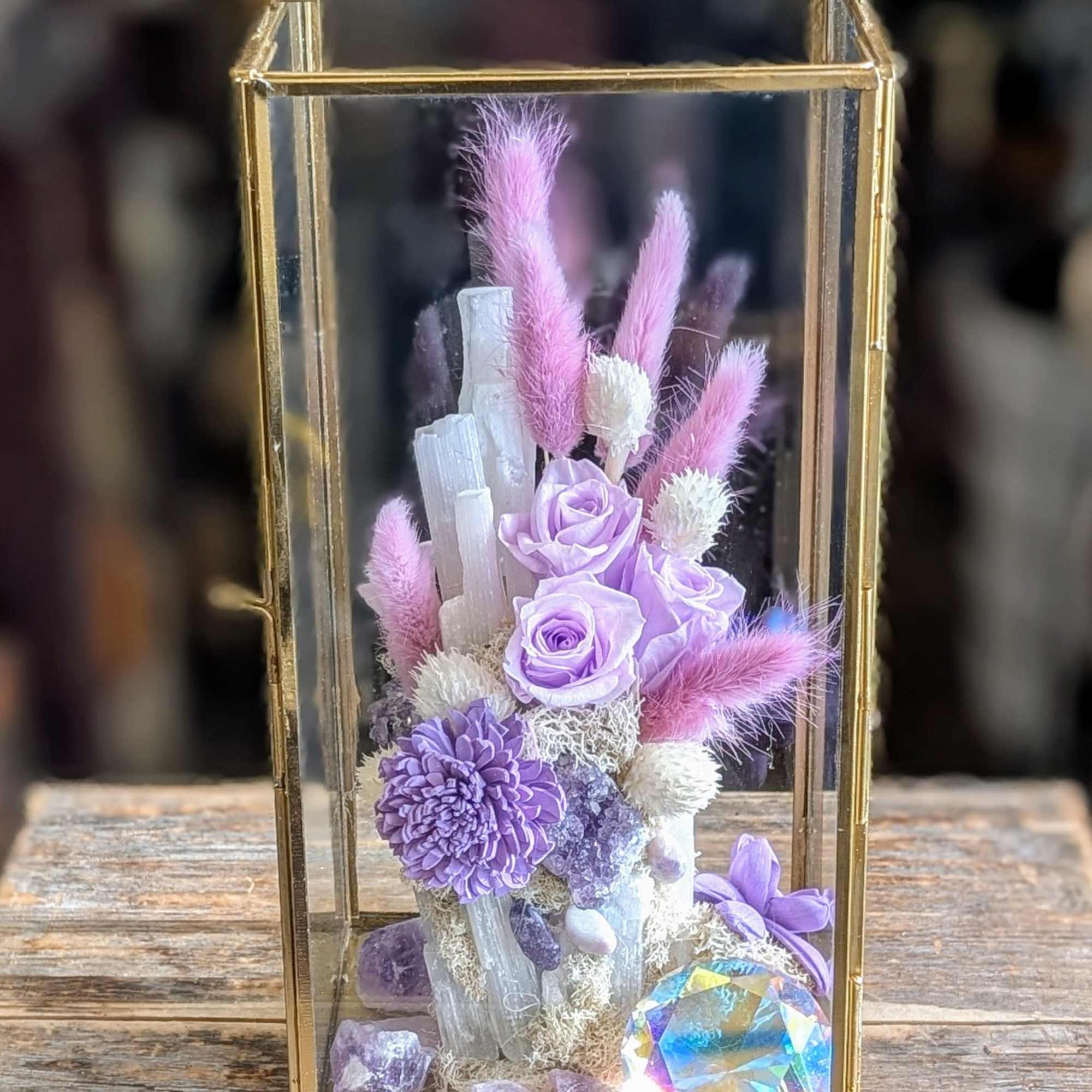 Lavender roses and purple flowers in a gold glass lantern