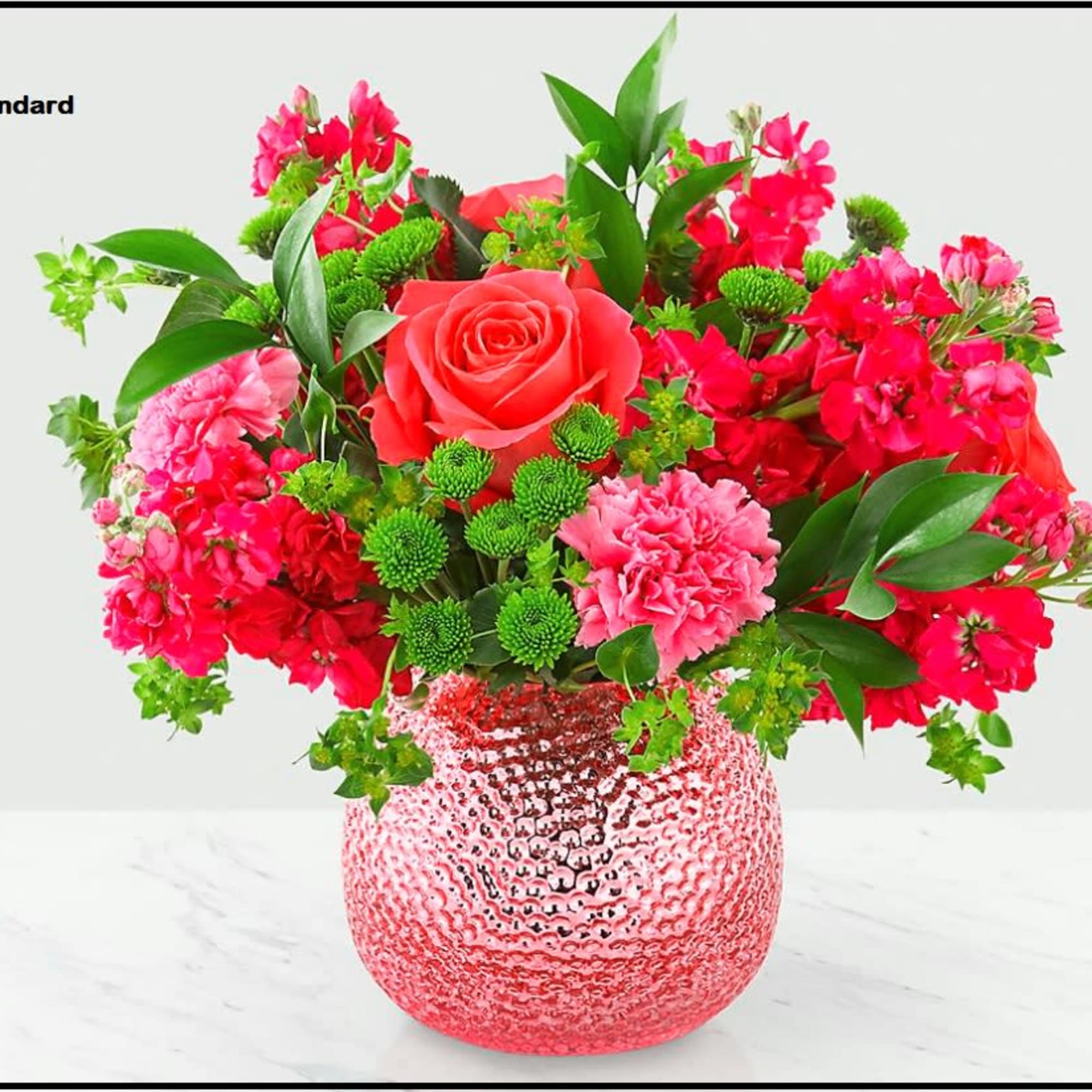 Pink and red mixed bouquet in a textured glass vase
