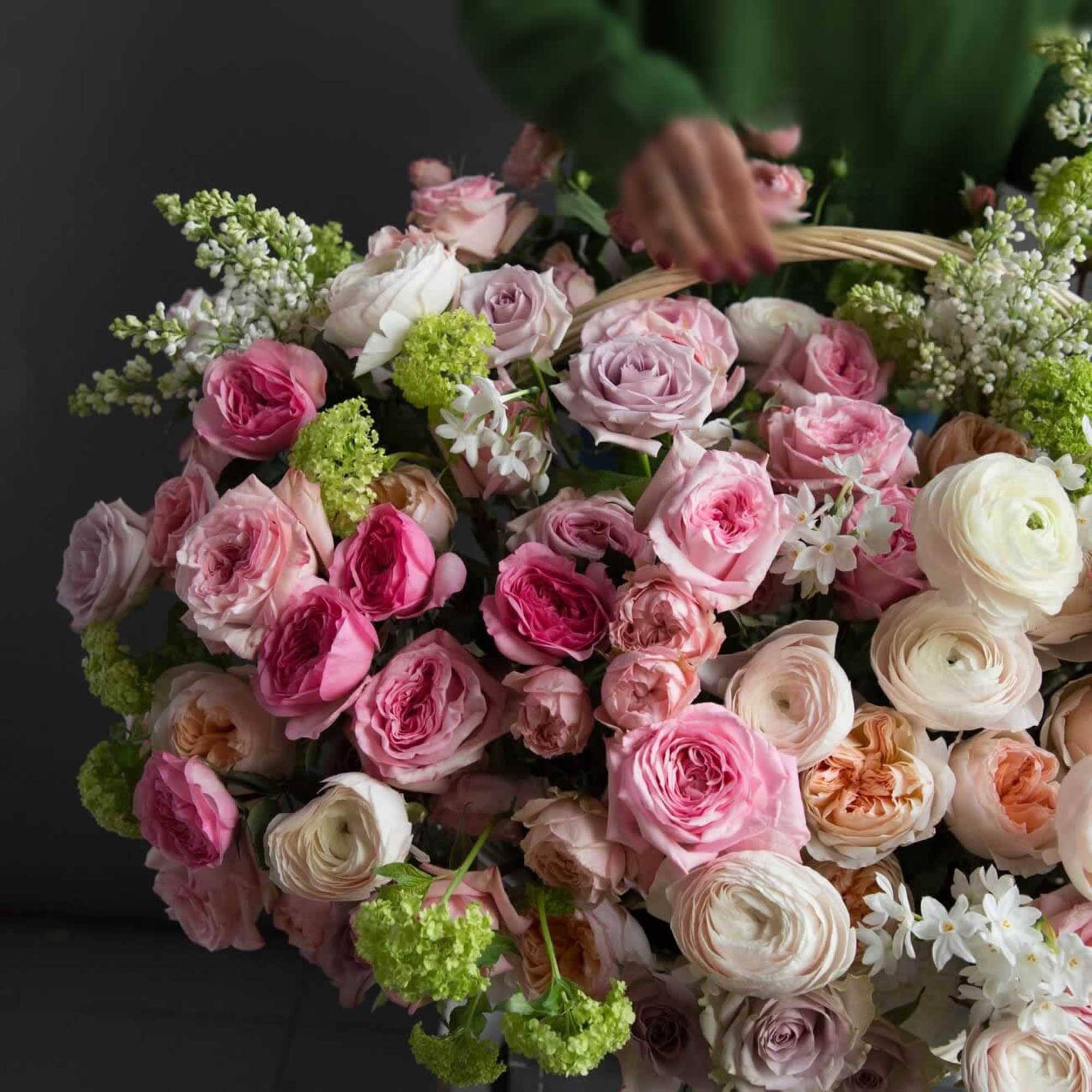 Large bouquet of pink and white roses with green accents
