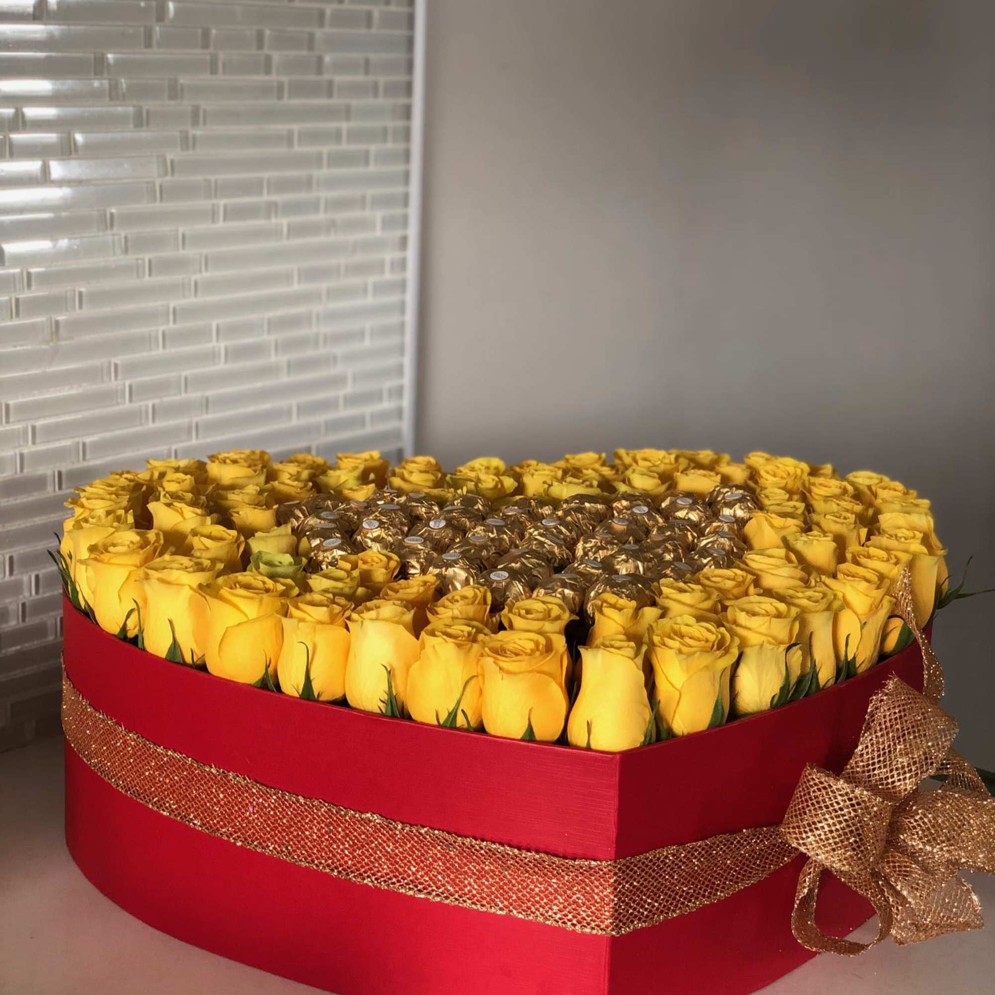 A large red heart box with 70-75 yellow roses around the edge
