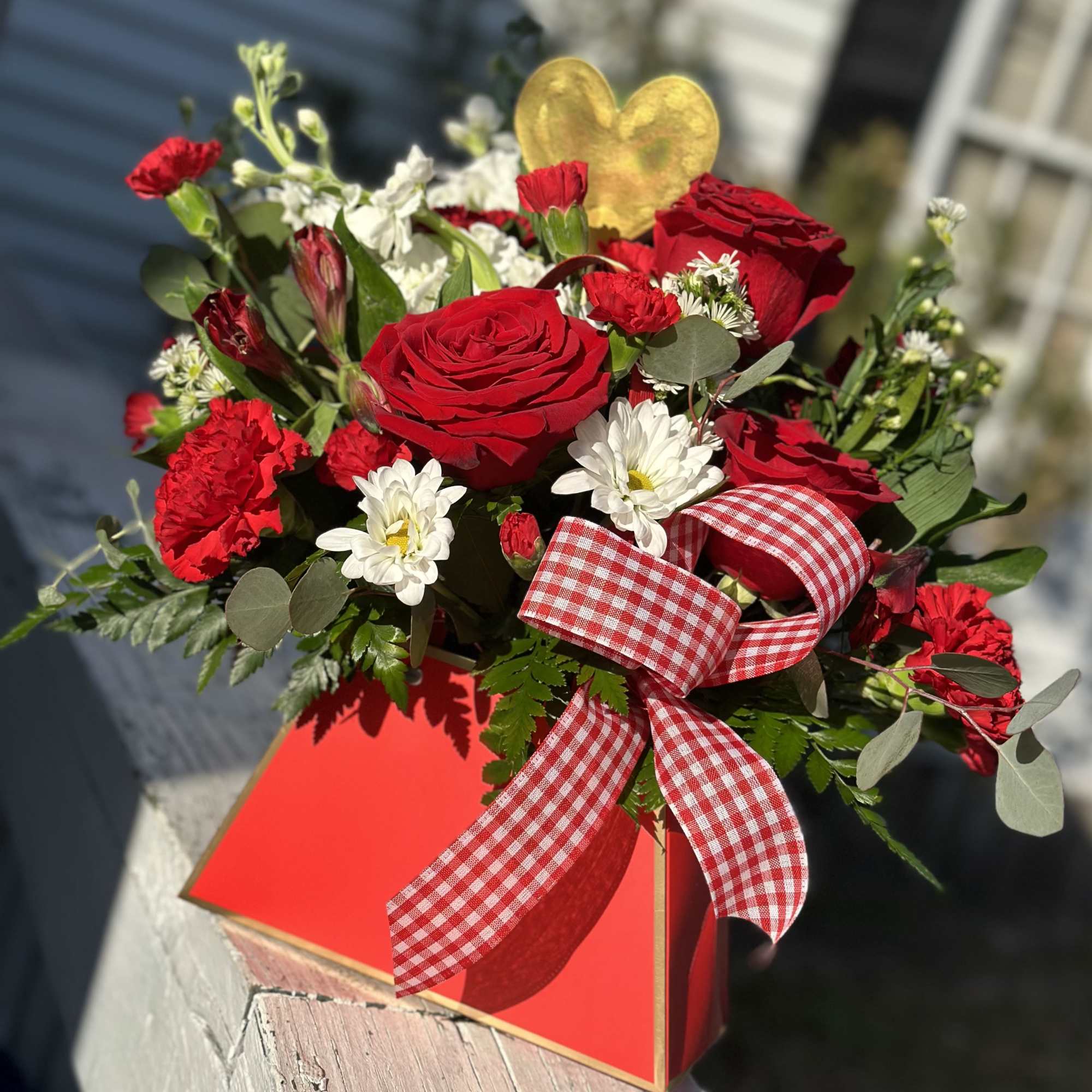Red roses and white daisies in a red gift box with a gingham ribbon, photo 2 of 2
