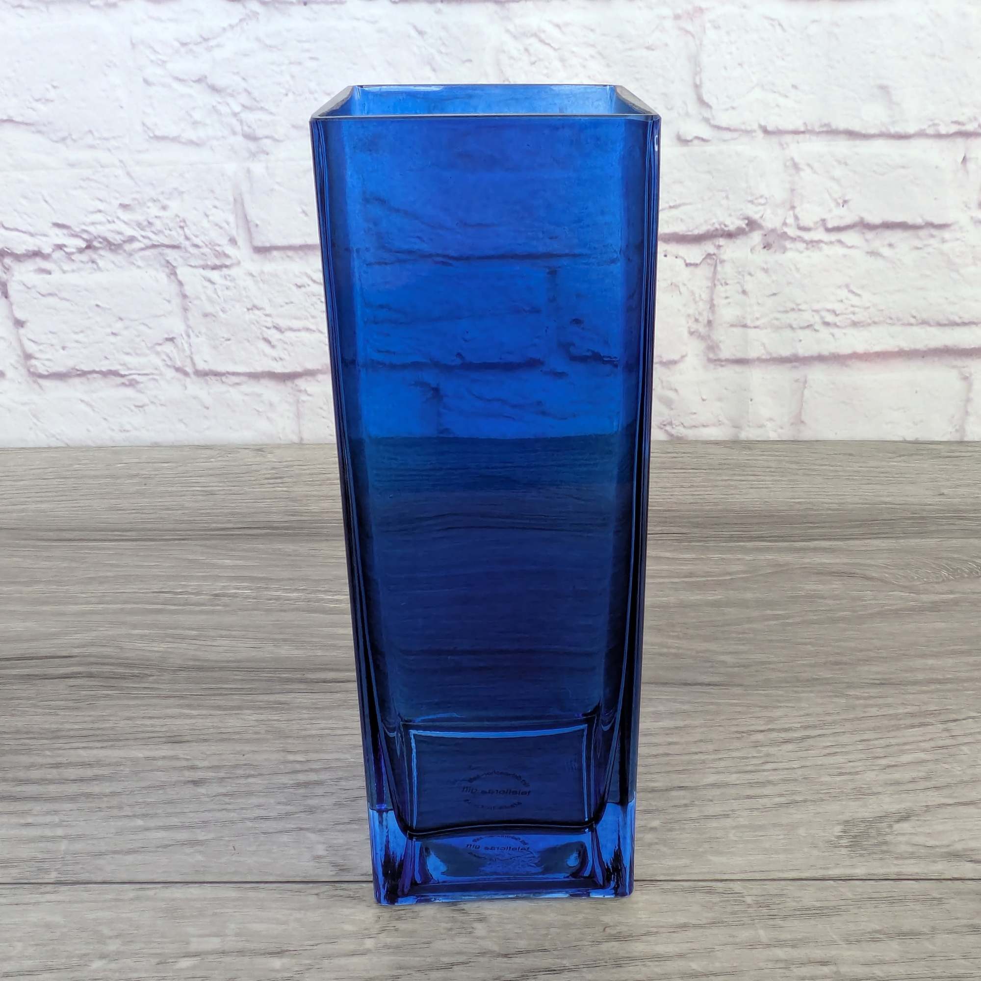 Tall blue glass vase with a square opening