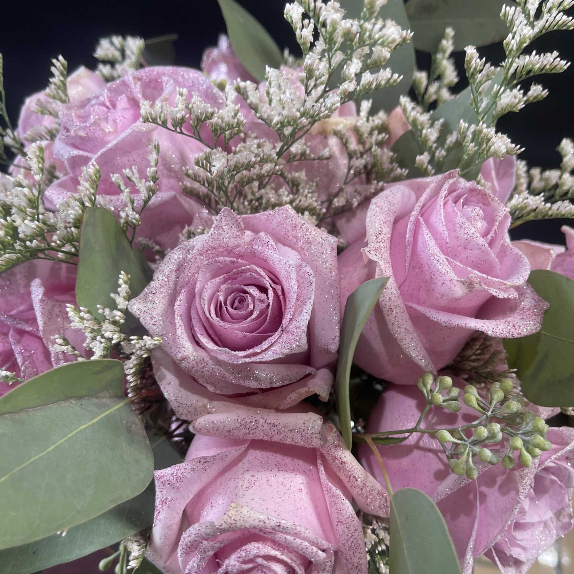 Pink glittered roses with white filler flowers and eucalyptus
