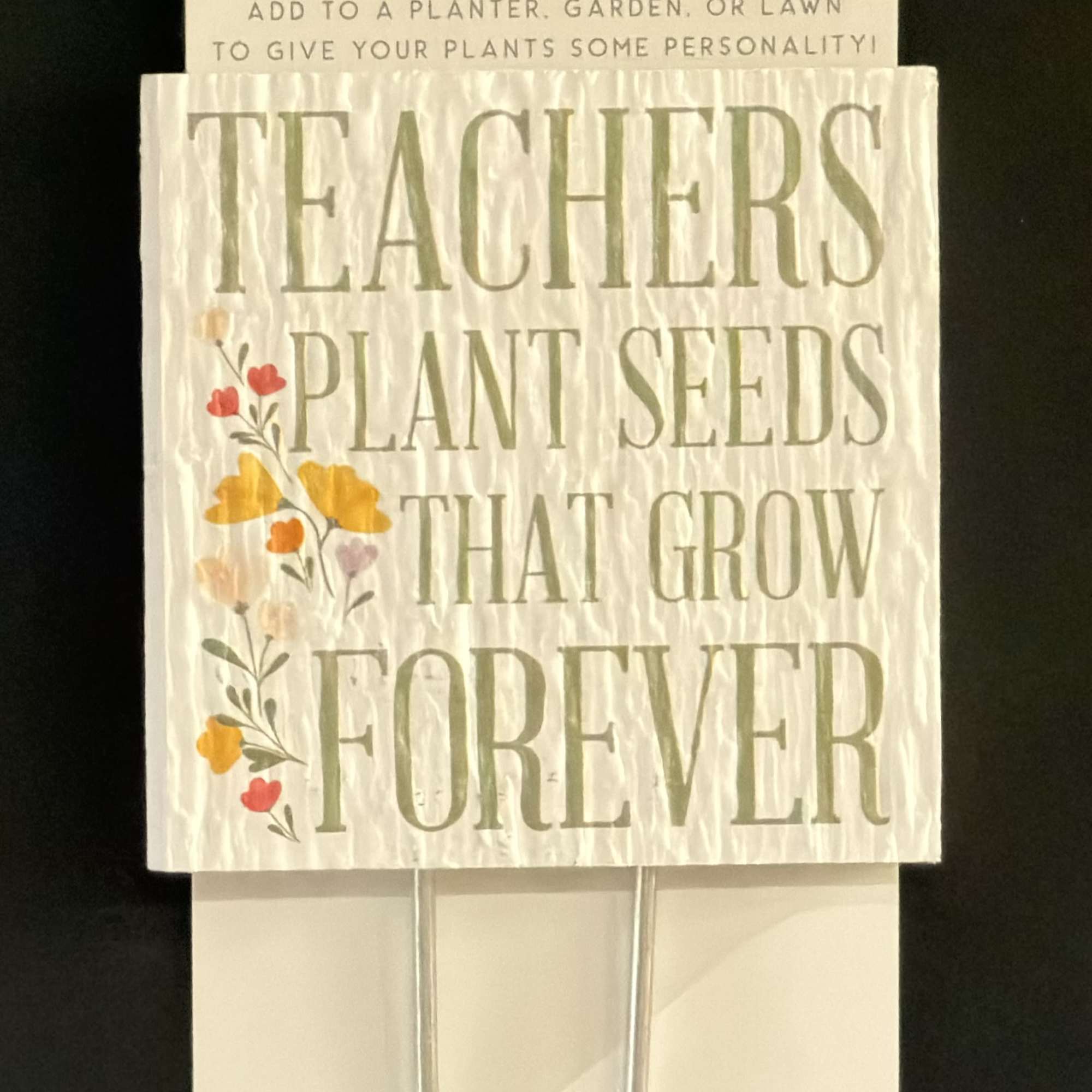 Decorative plant sign with the words "Teachers Plant Seeds That Grow Forever"