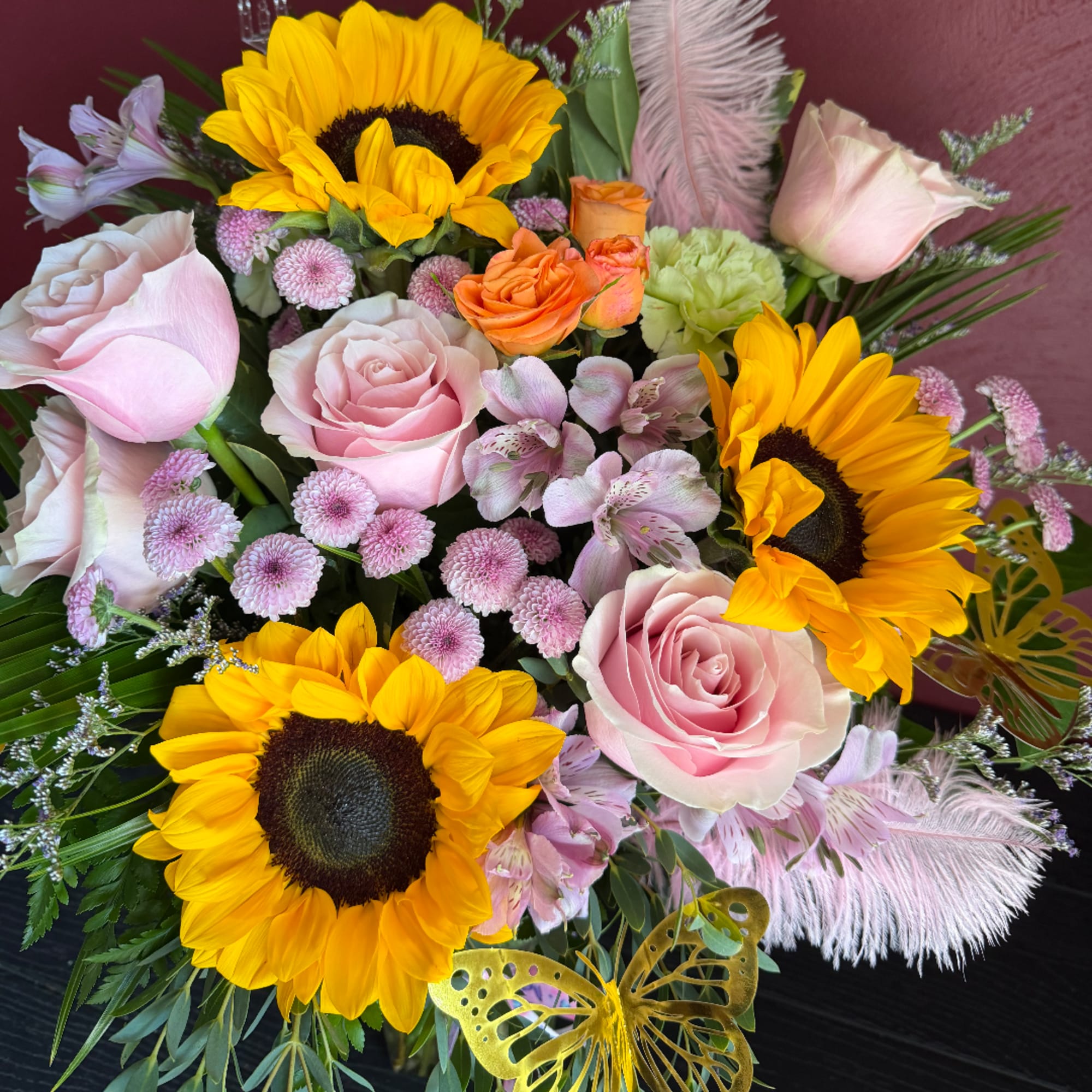 Bouquet with pink roses, sunflowers, and small pink blooms