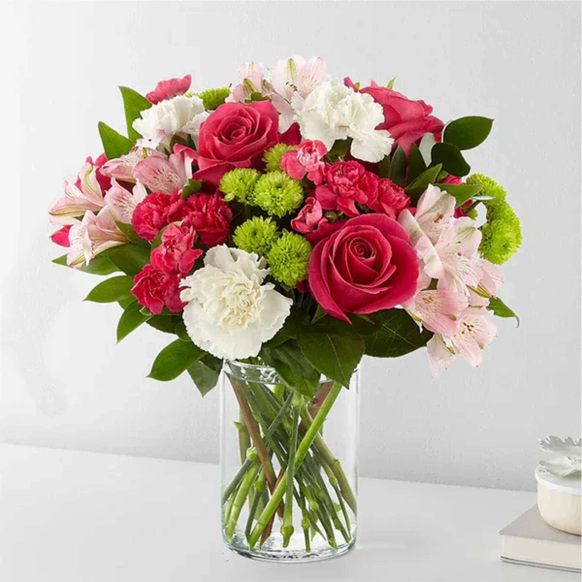 Pink and white mixed bouquet in a clear glass vase