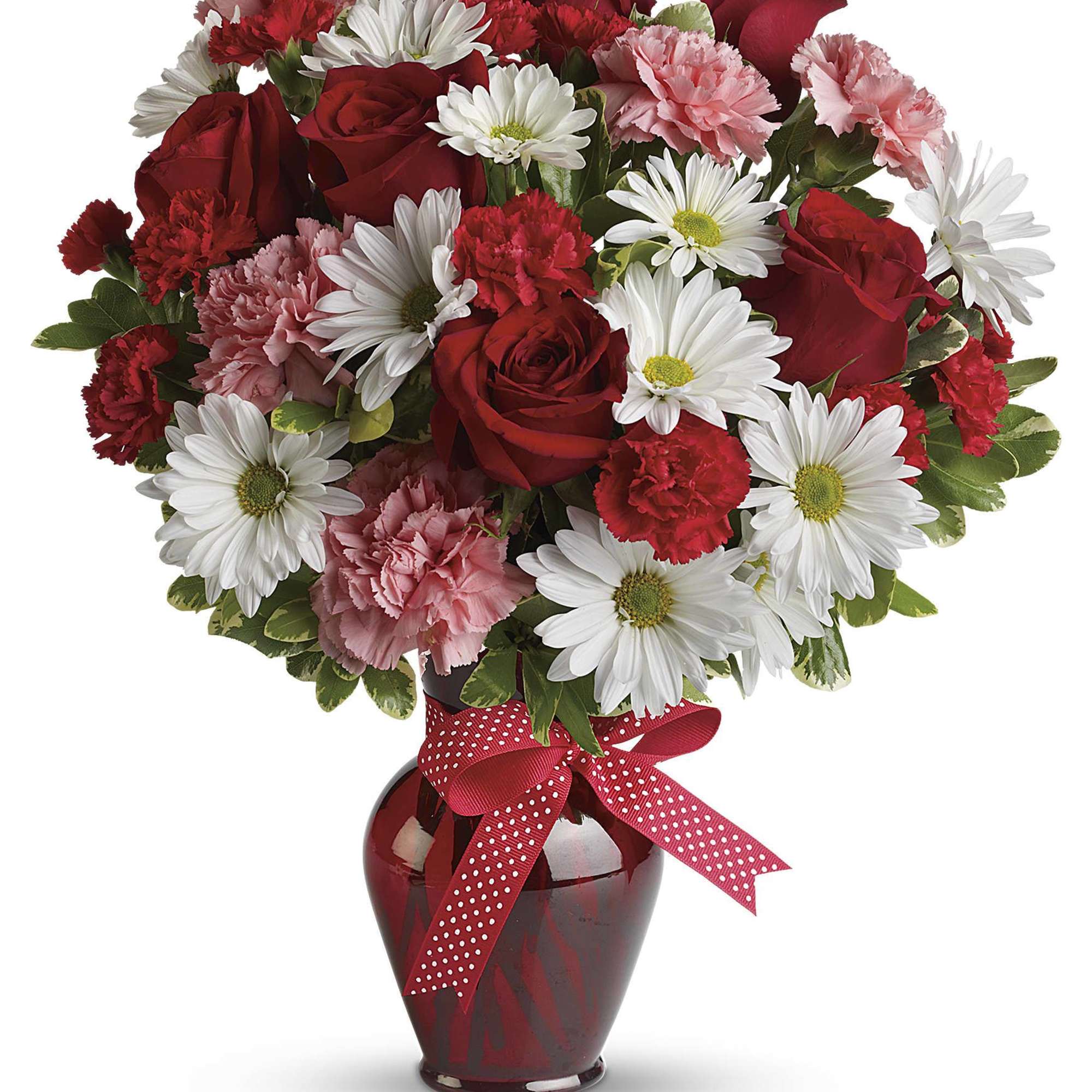 Red roses, white daisies, and pink carnations in a red vase with a ribbon