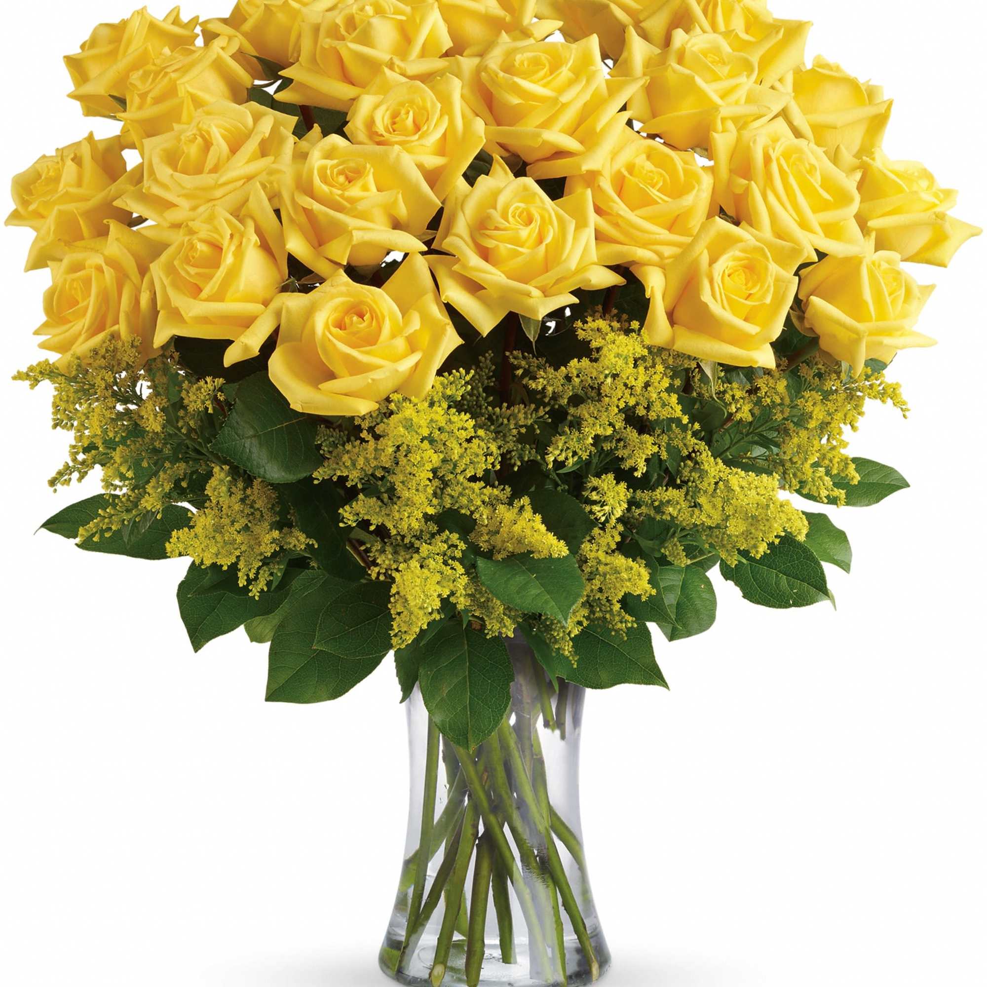 Yellow roses arranged in a clear glass vase with green filler