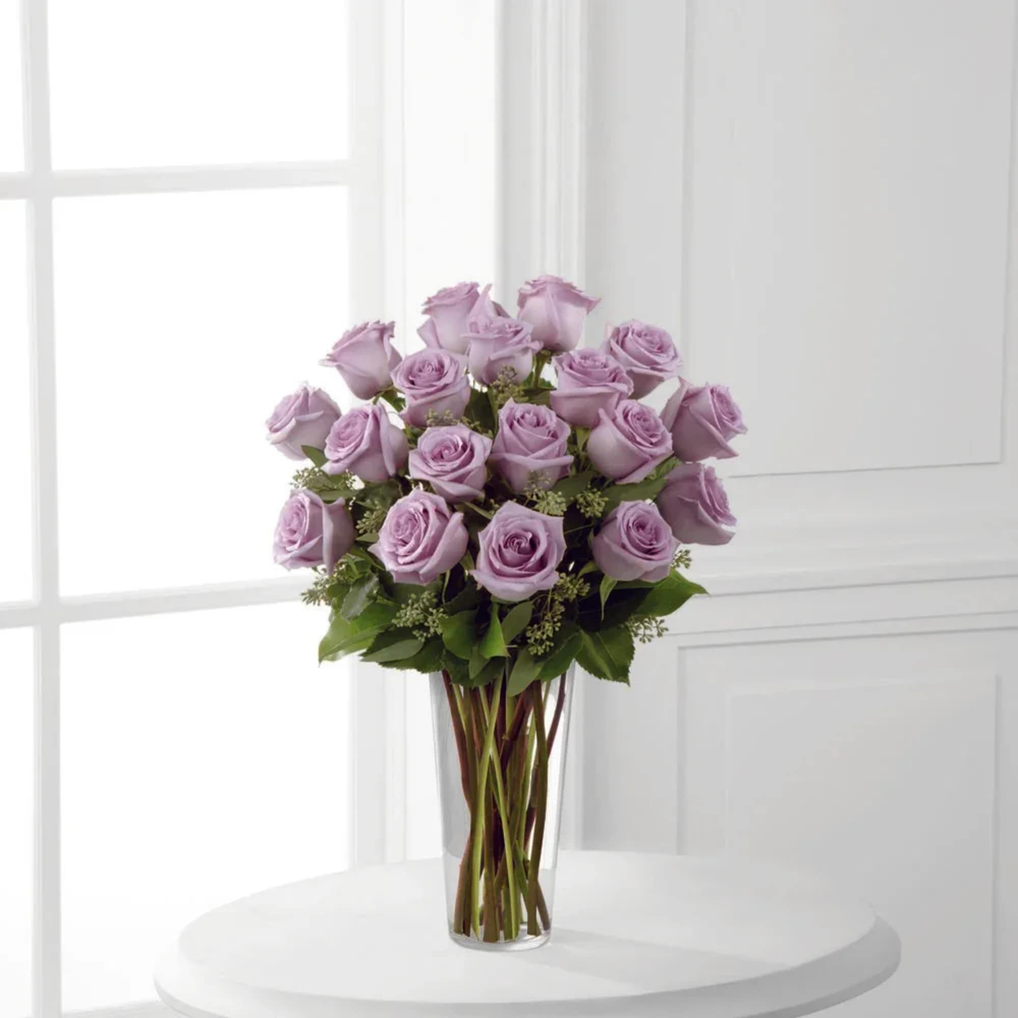 Lavender rose bouquet in a clear glass vase