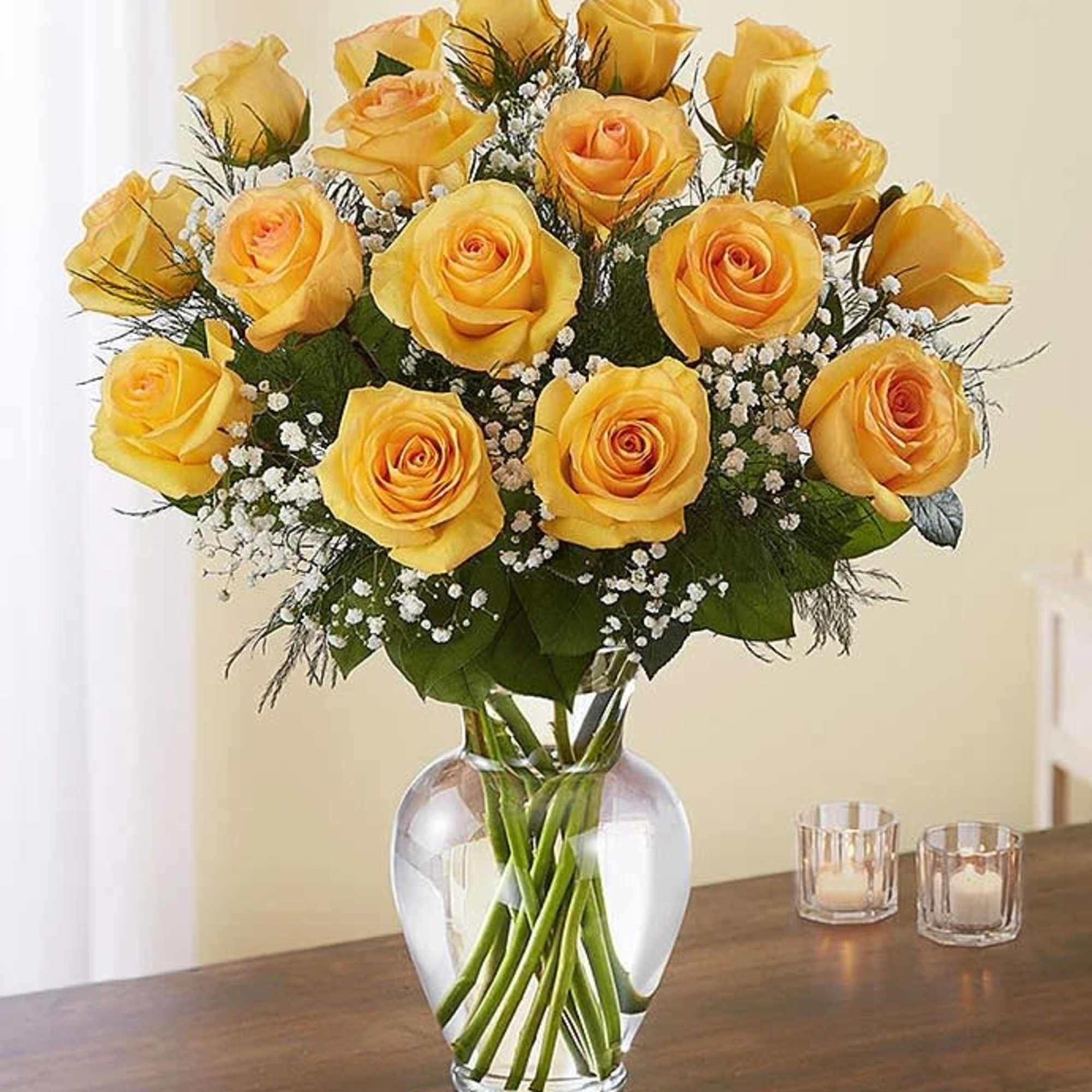 Yellow roses arranged in a clear glass vase