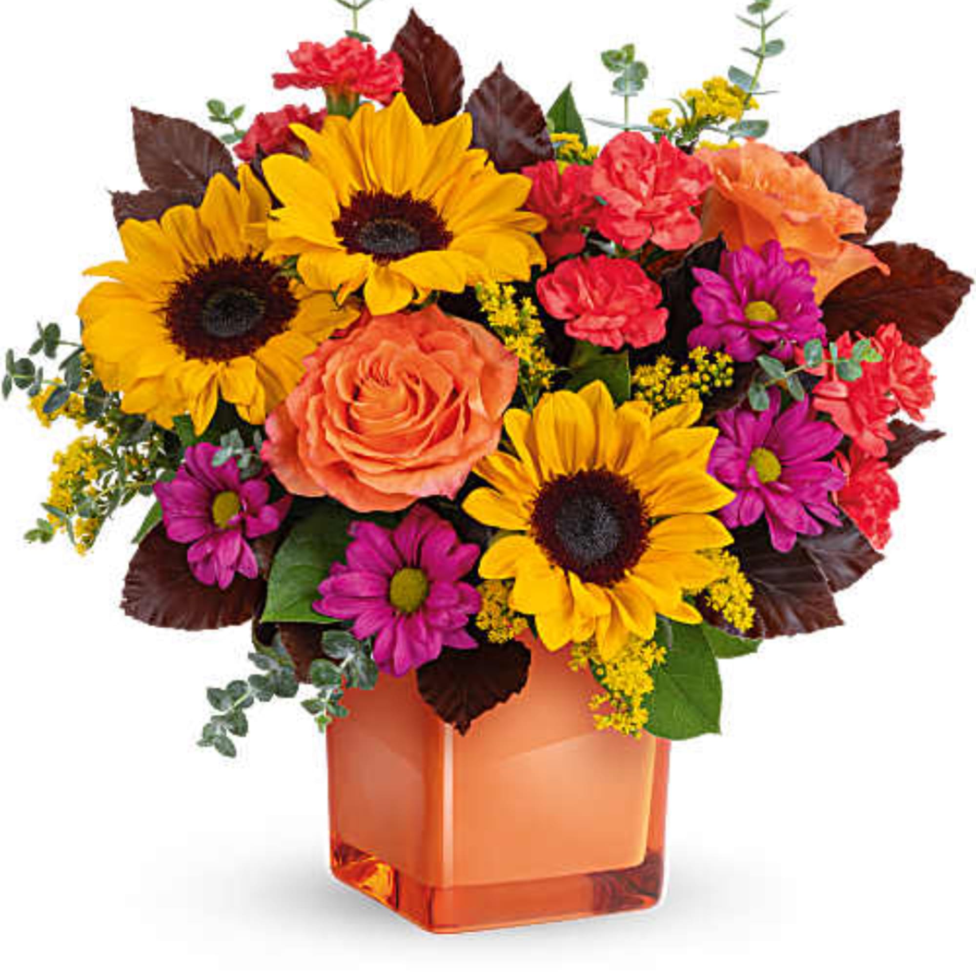 Mixed bouquet with sunflowers, roses, and daisies in an orange glass vase
