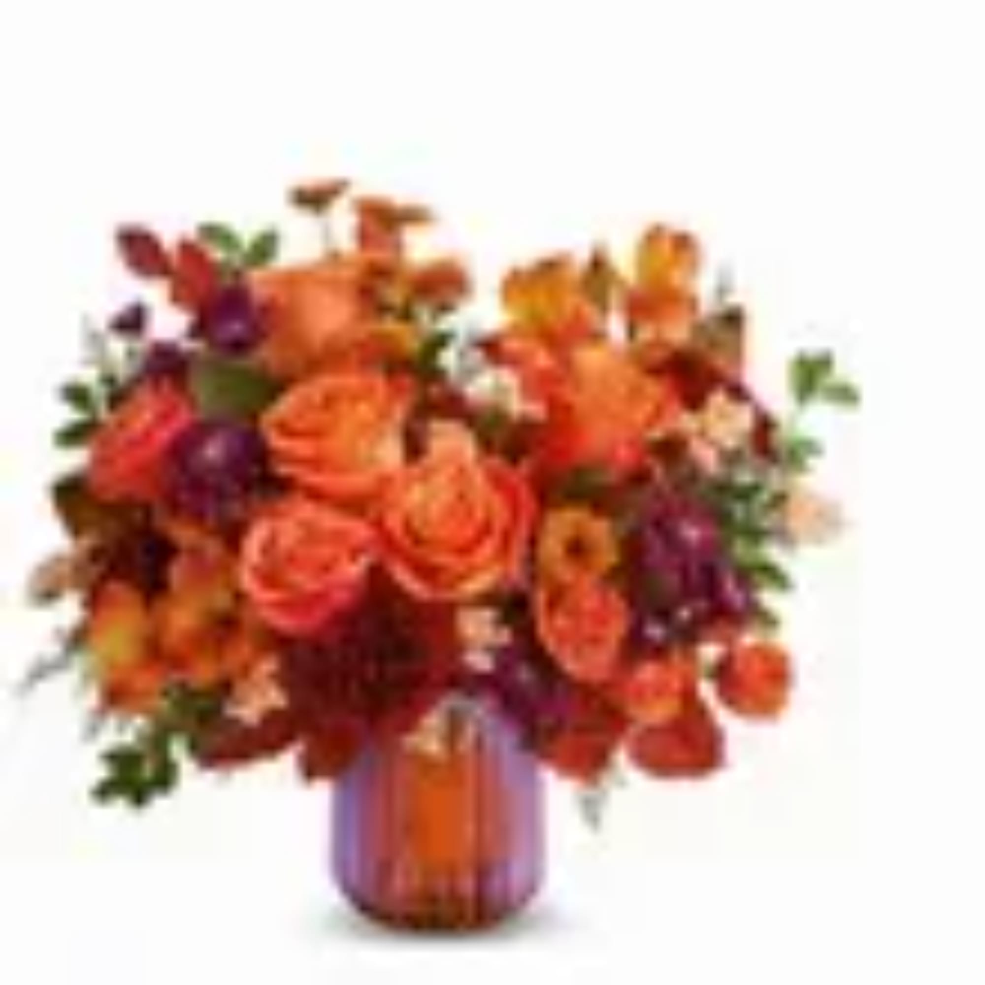Orange and purple floral arrangement in a glass vase