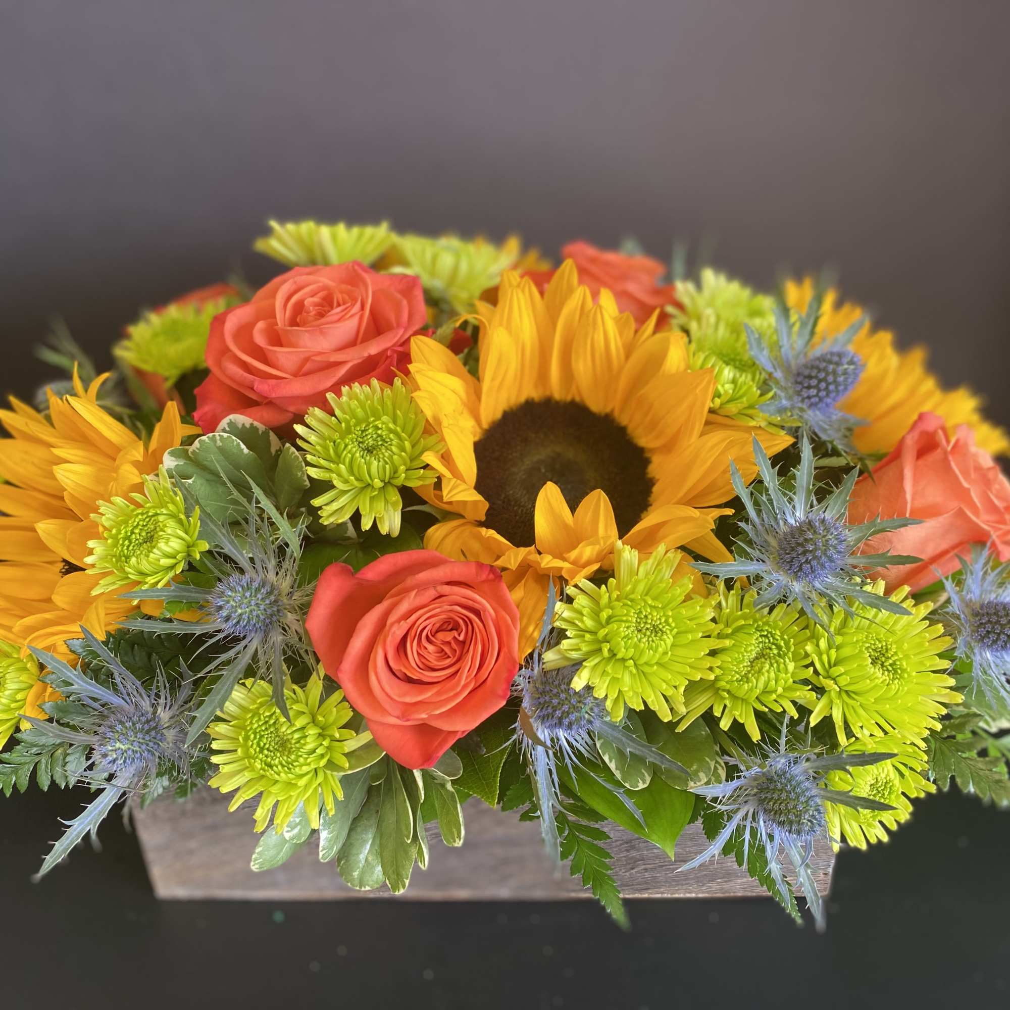 A Bright and Cheerful Low and Lush Centerpiece in a Wooden Box.