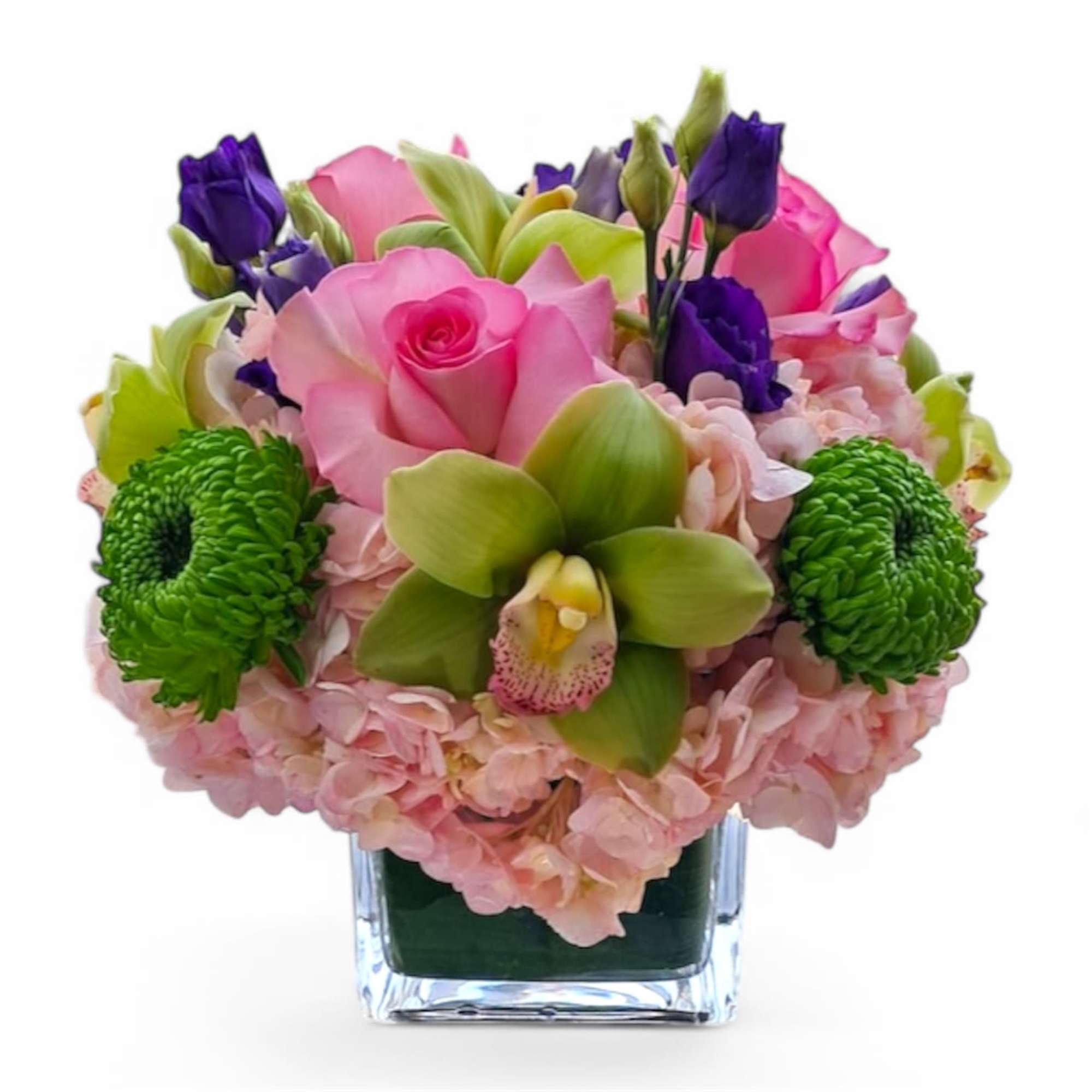 Pink roses and green orchids in a clear square vase