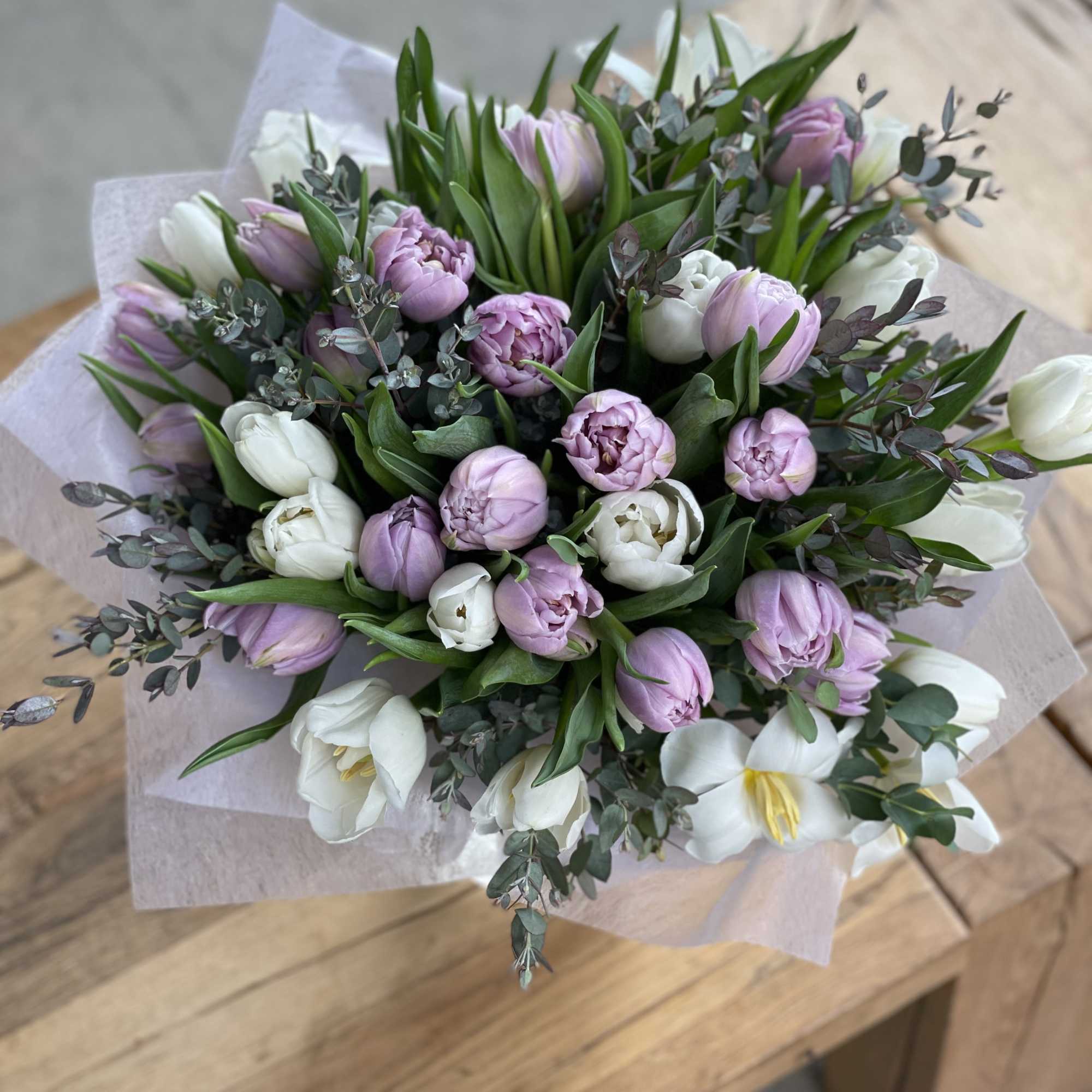 Bouquet of lavender and white tulips with eucalyptus wrapping