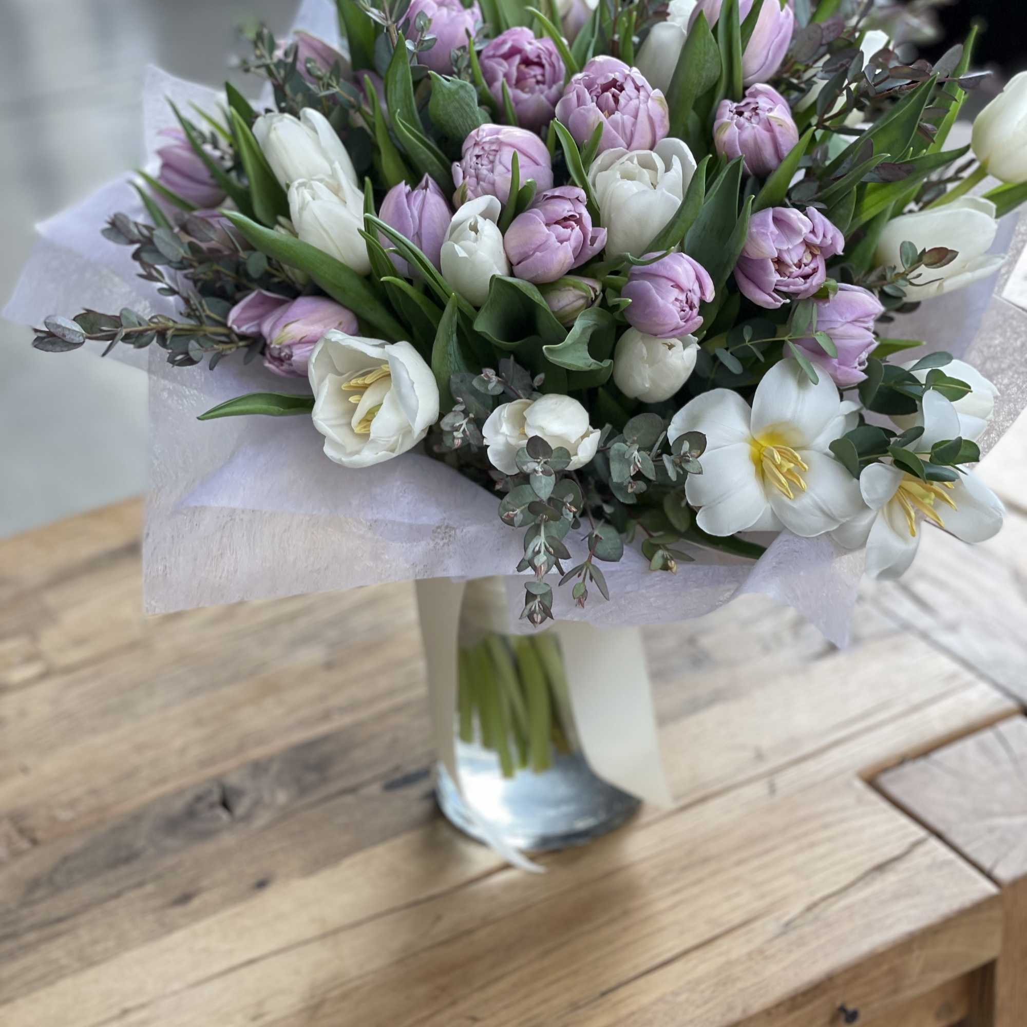 Bouquet of pink and white tulips in a glass vase