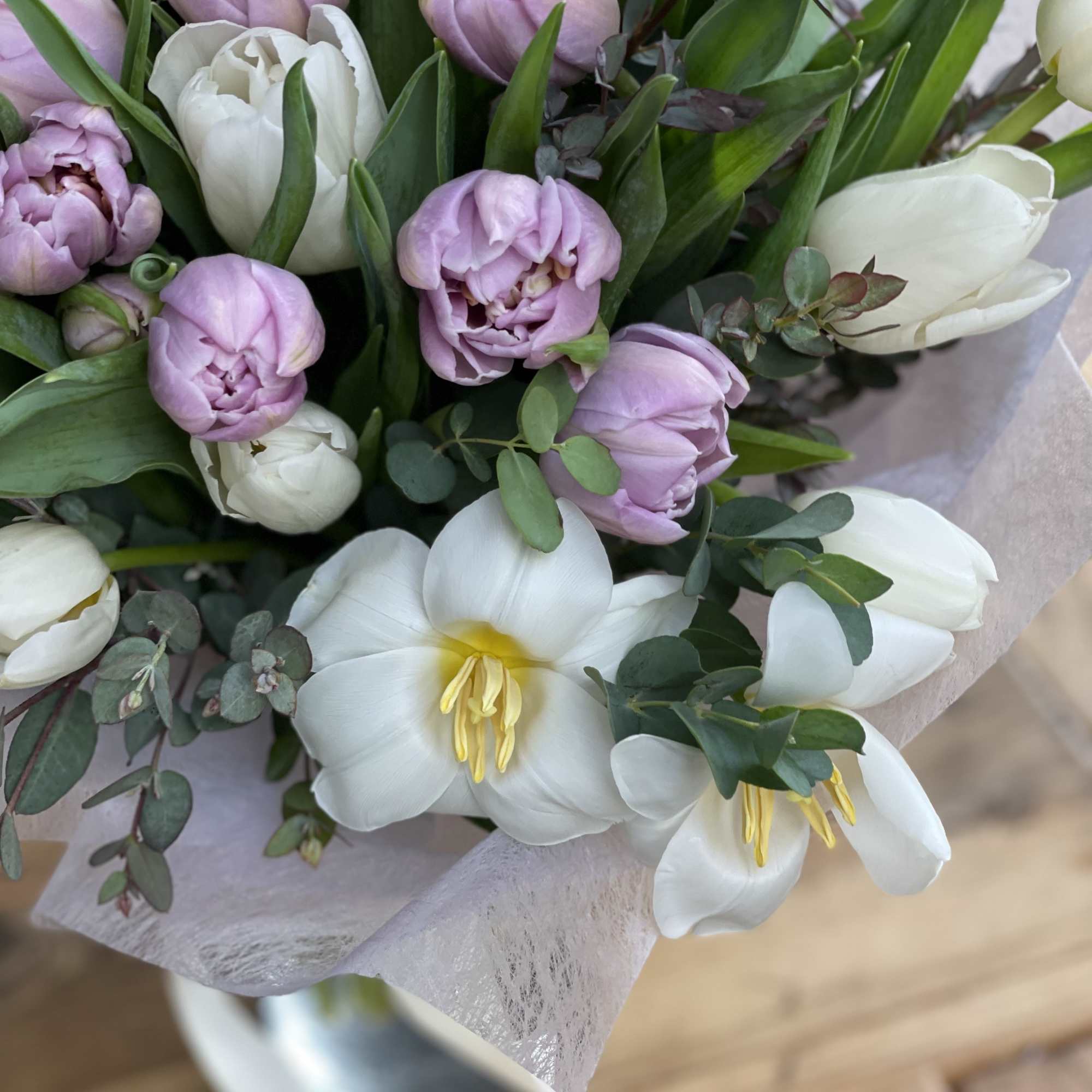 Bouquet of white and pale pink tulips with eucalyptus