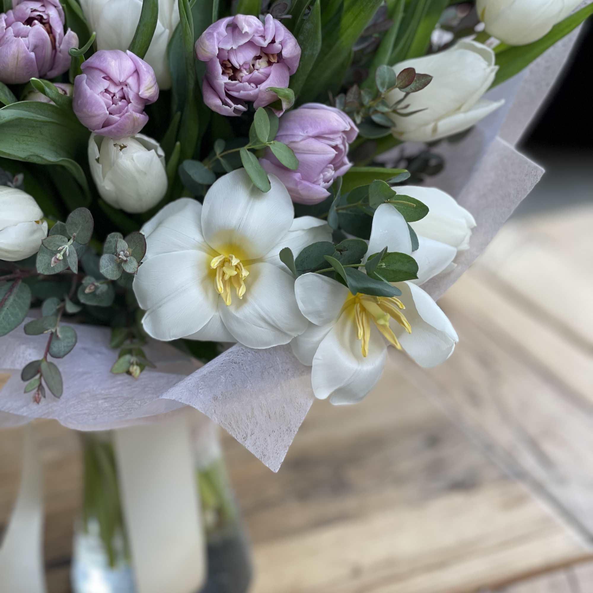 Bouquet of white and lavender tulips with eucalyptus