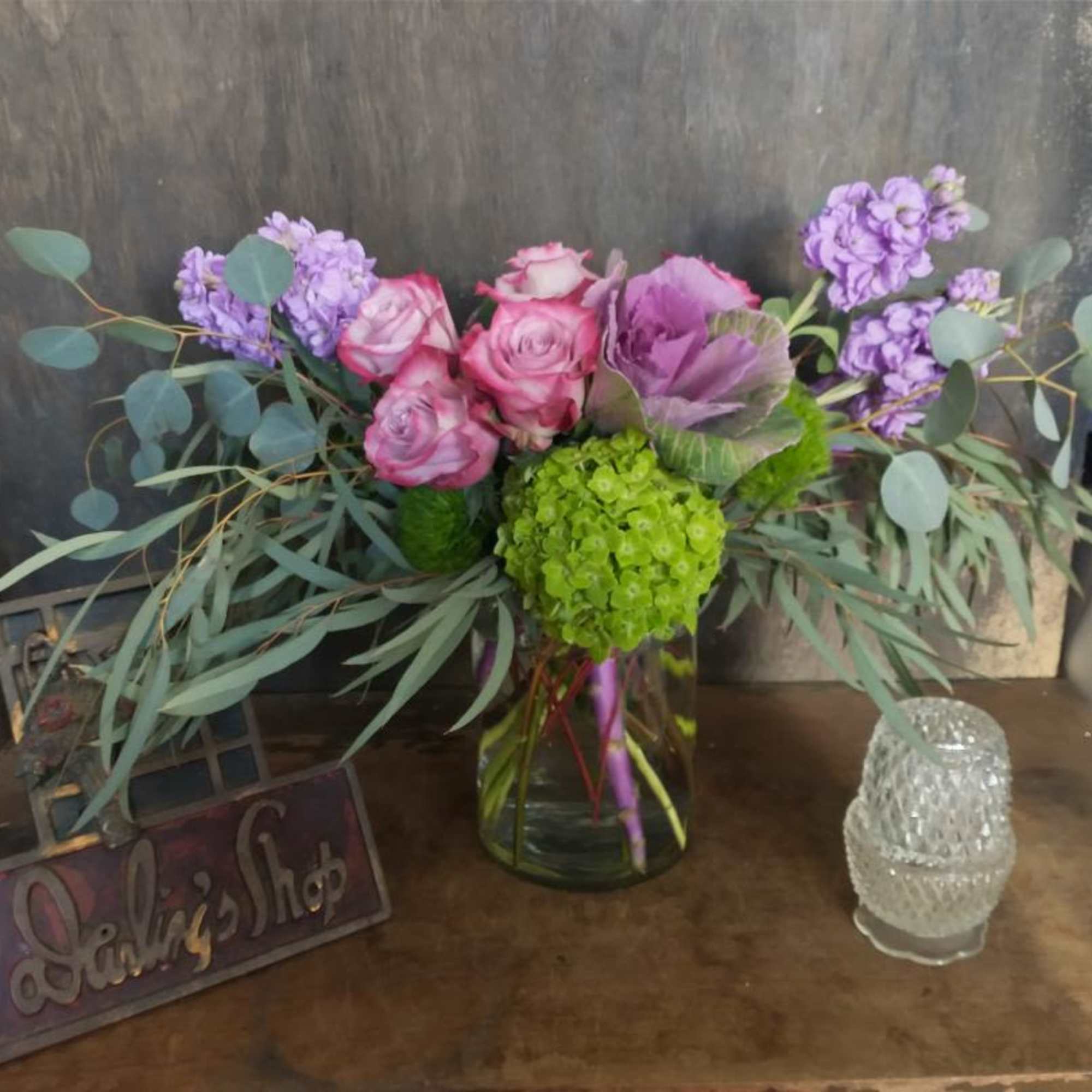 Pink and purple floral arrangement in a glass vase