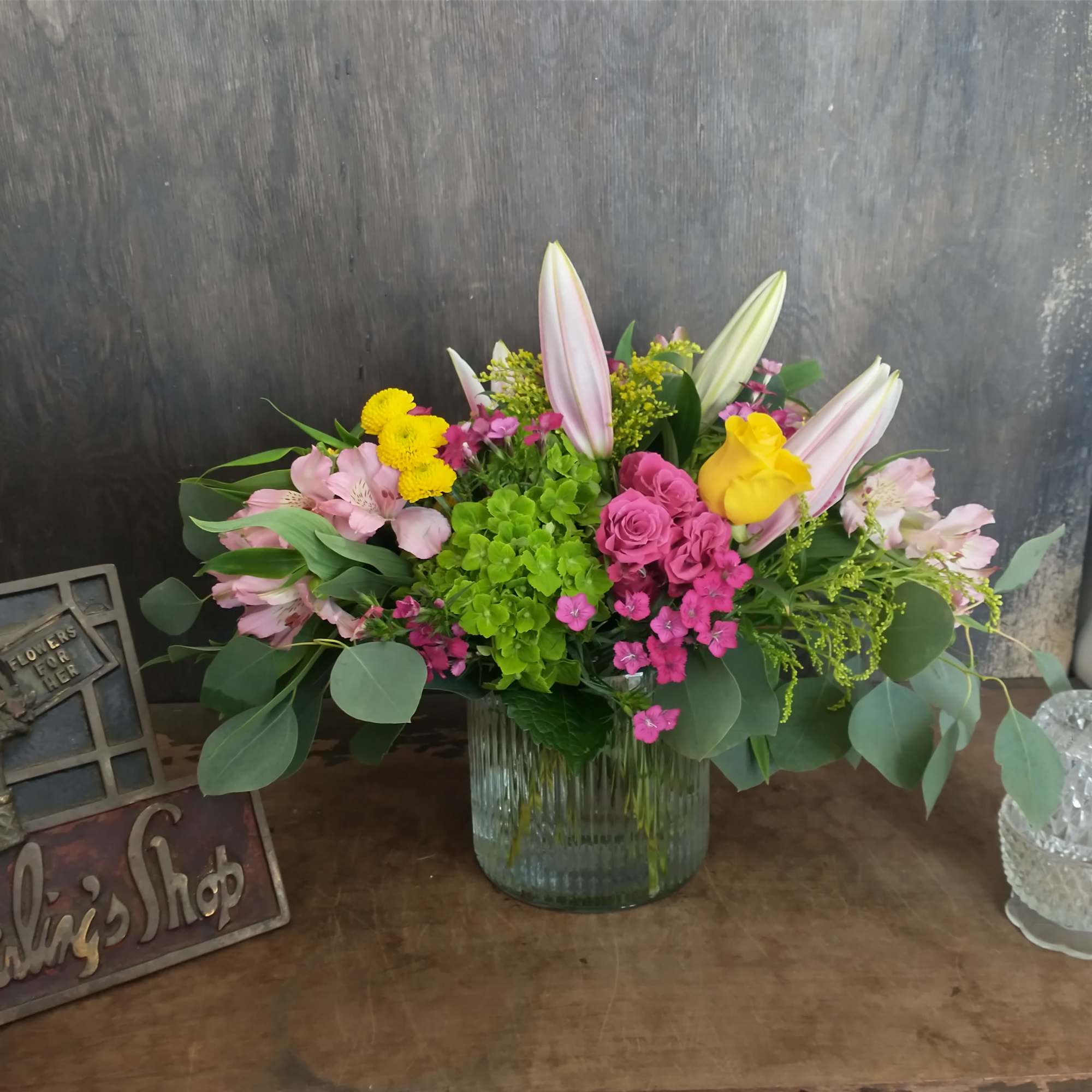 Mixed bouquet in a glass vase with pink lilies and roses