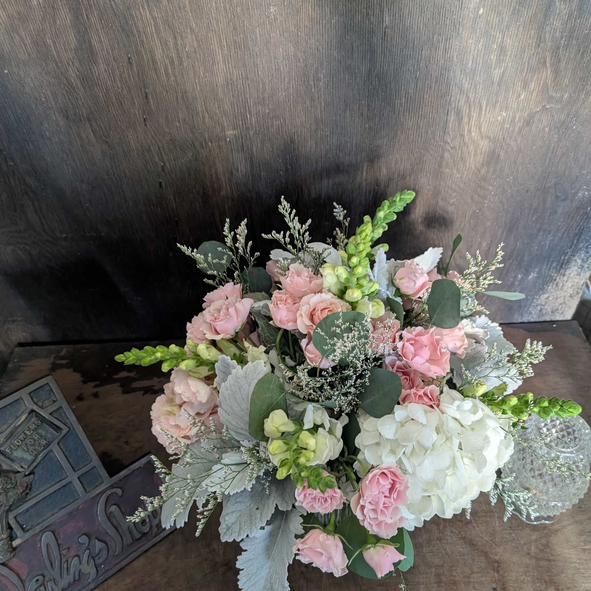 Pink and white floral arrangement with hydrangeas and roses