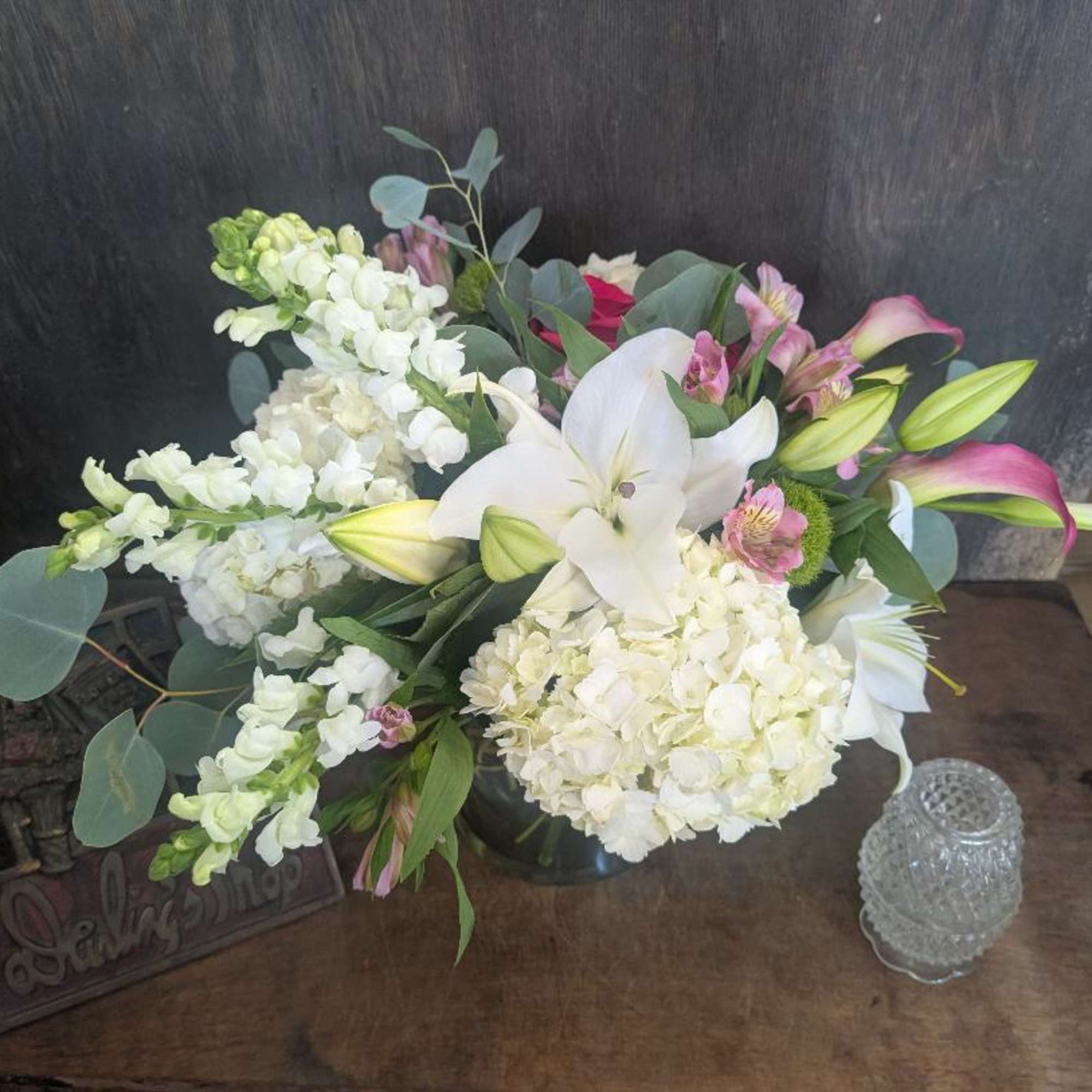 White lilies and hydrangeas with pink calla lilies in a vase