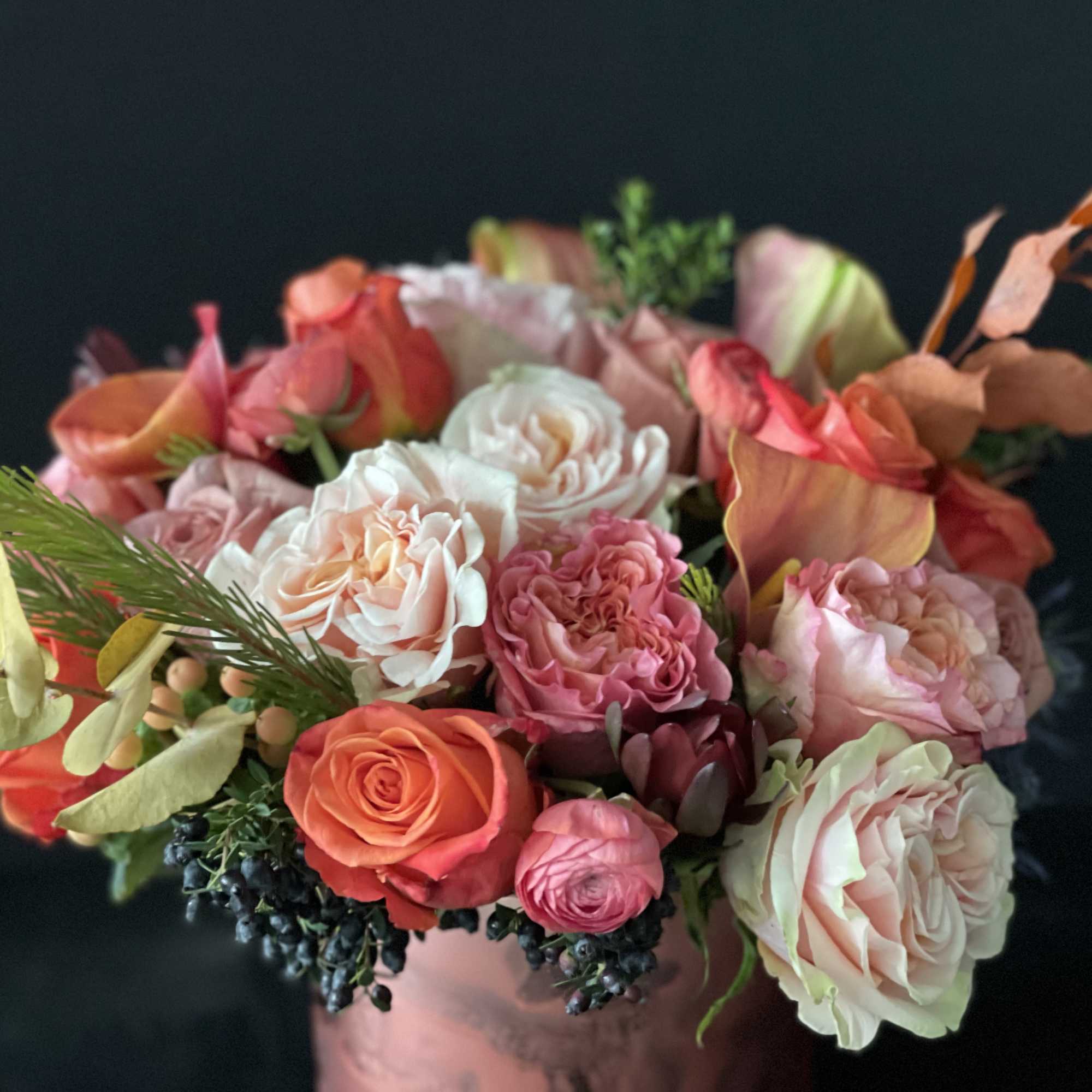 Bouquet of pink, peach, and white roses in a vase
