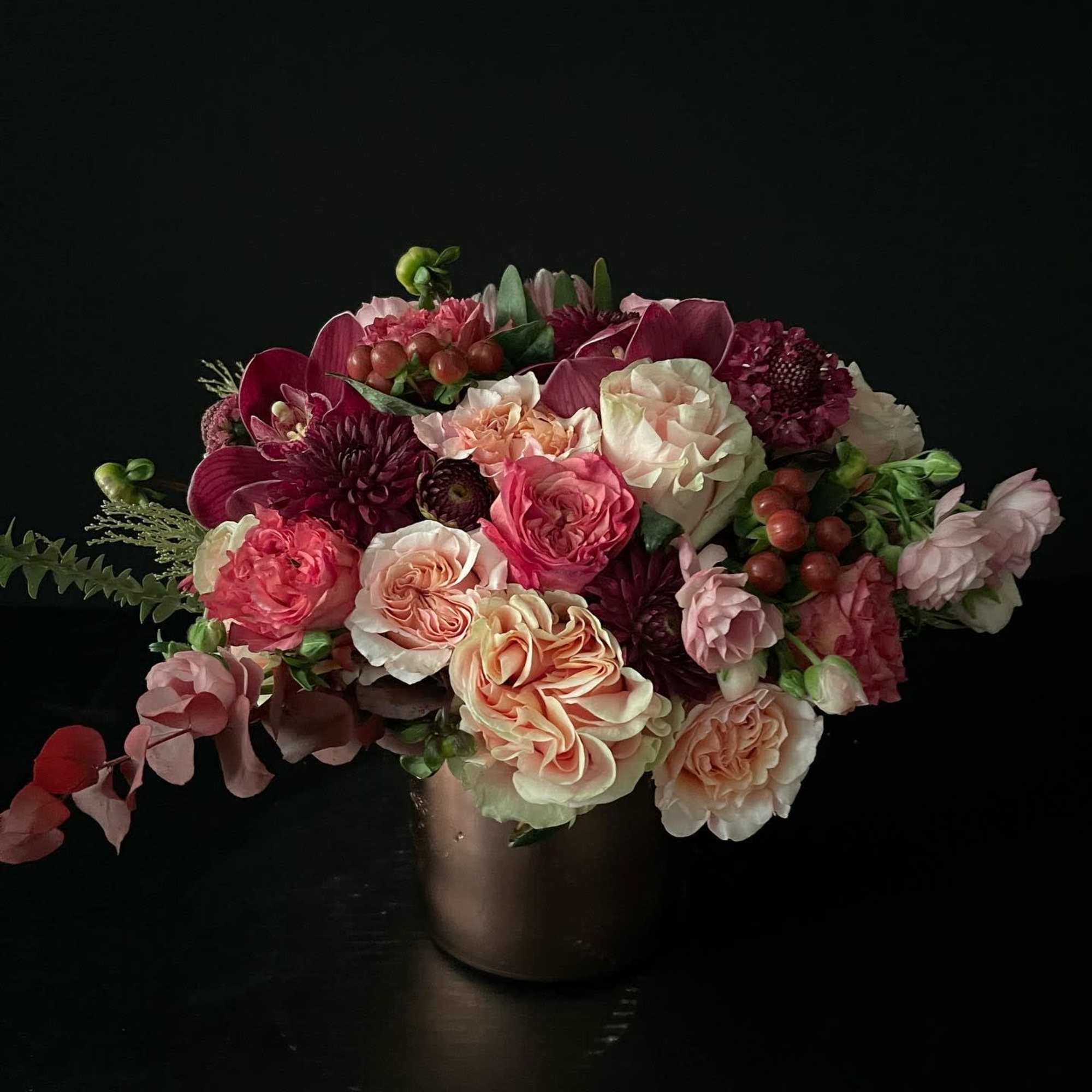 Mixed pink and cream bouquet in a dark vase