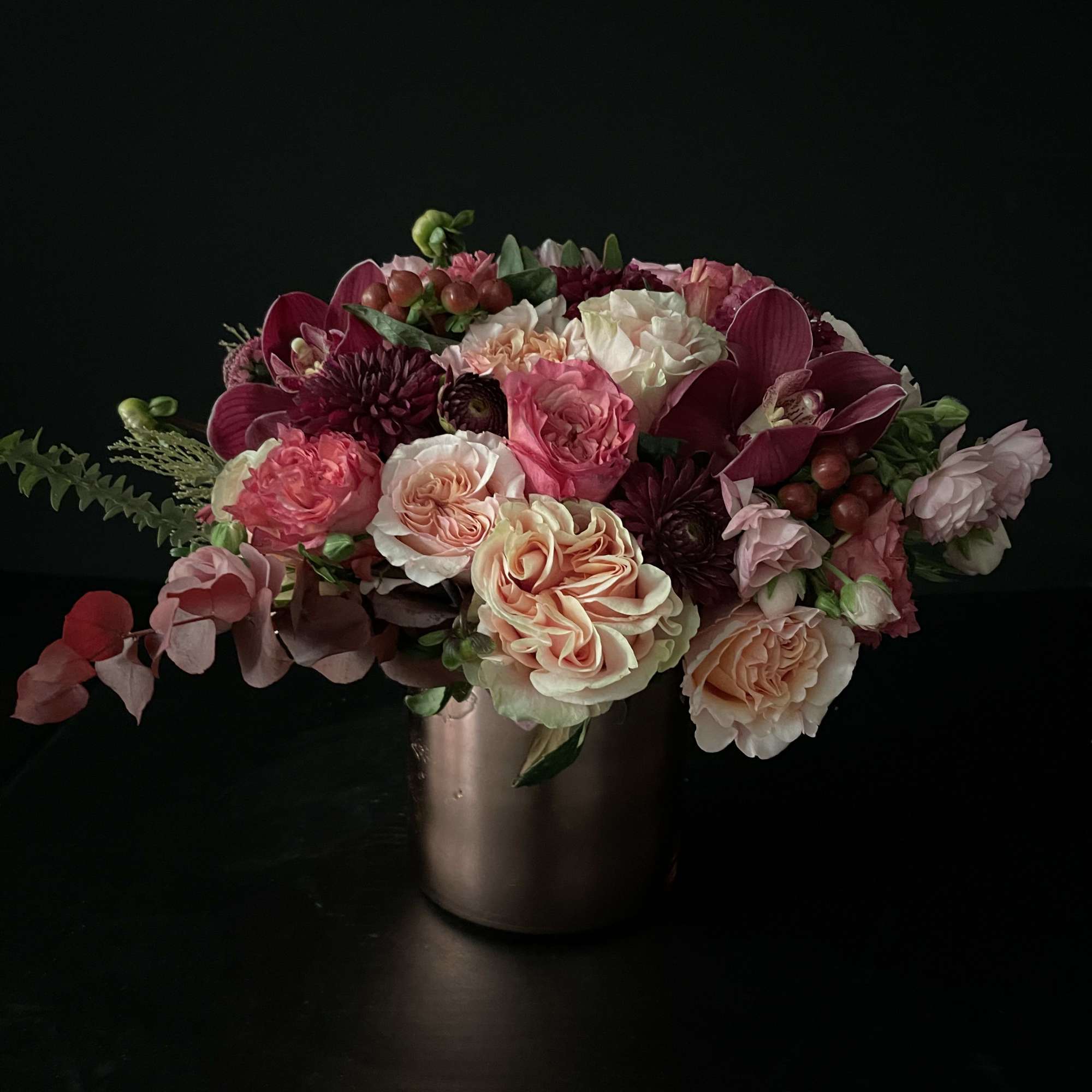 Pink and cream rose bouquet in a metallic vase