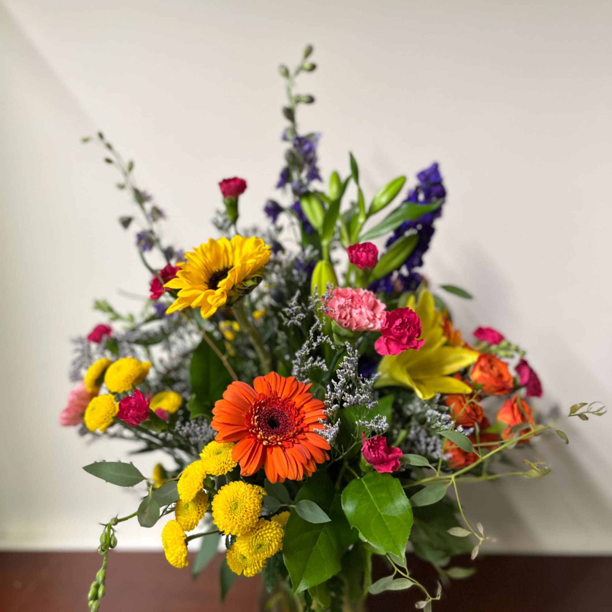 Mixed bouquet with sunflowers, gerbera daisies, lilies, and carnations