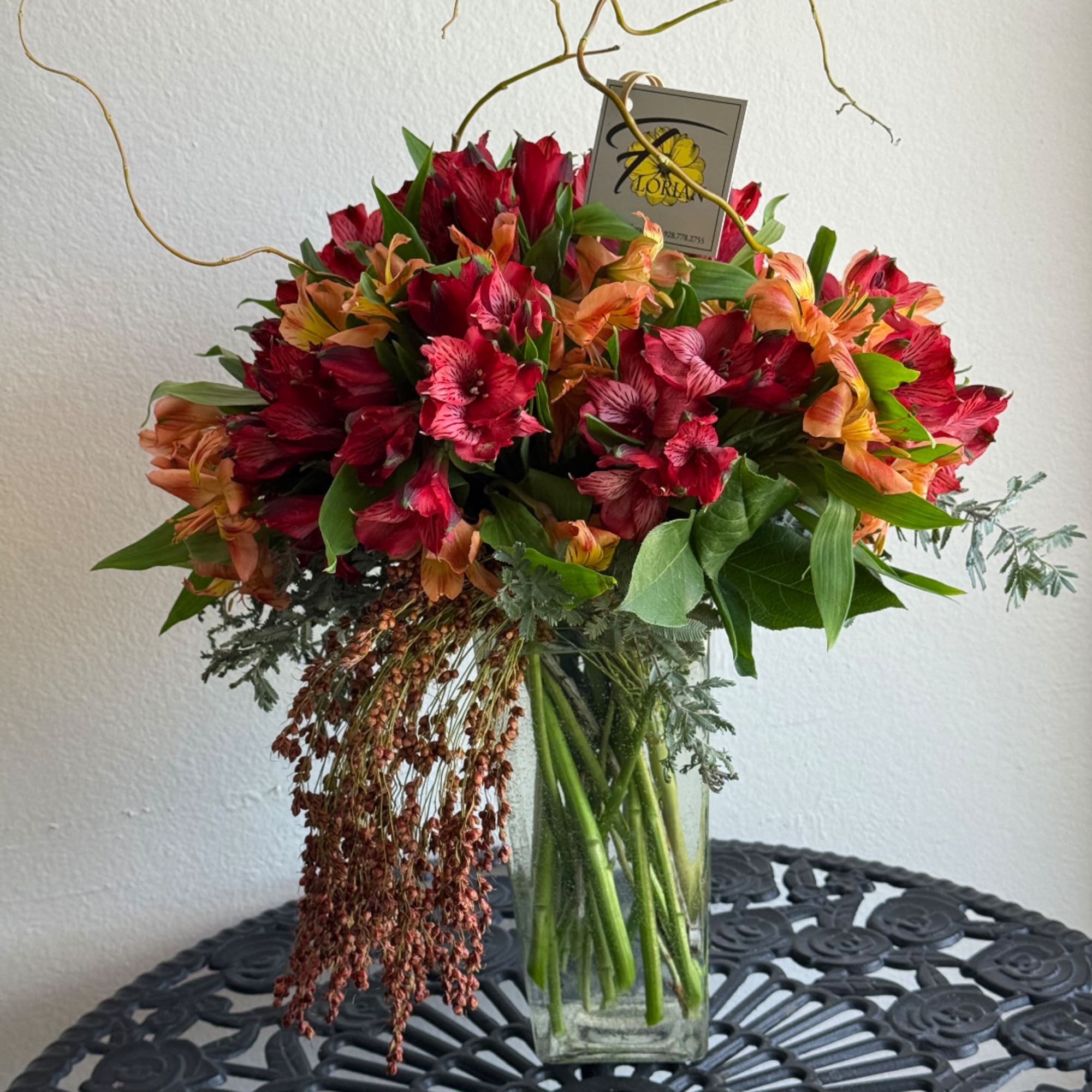 Bouquet of red and orange flowers in a clear glass vase