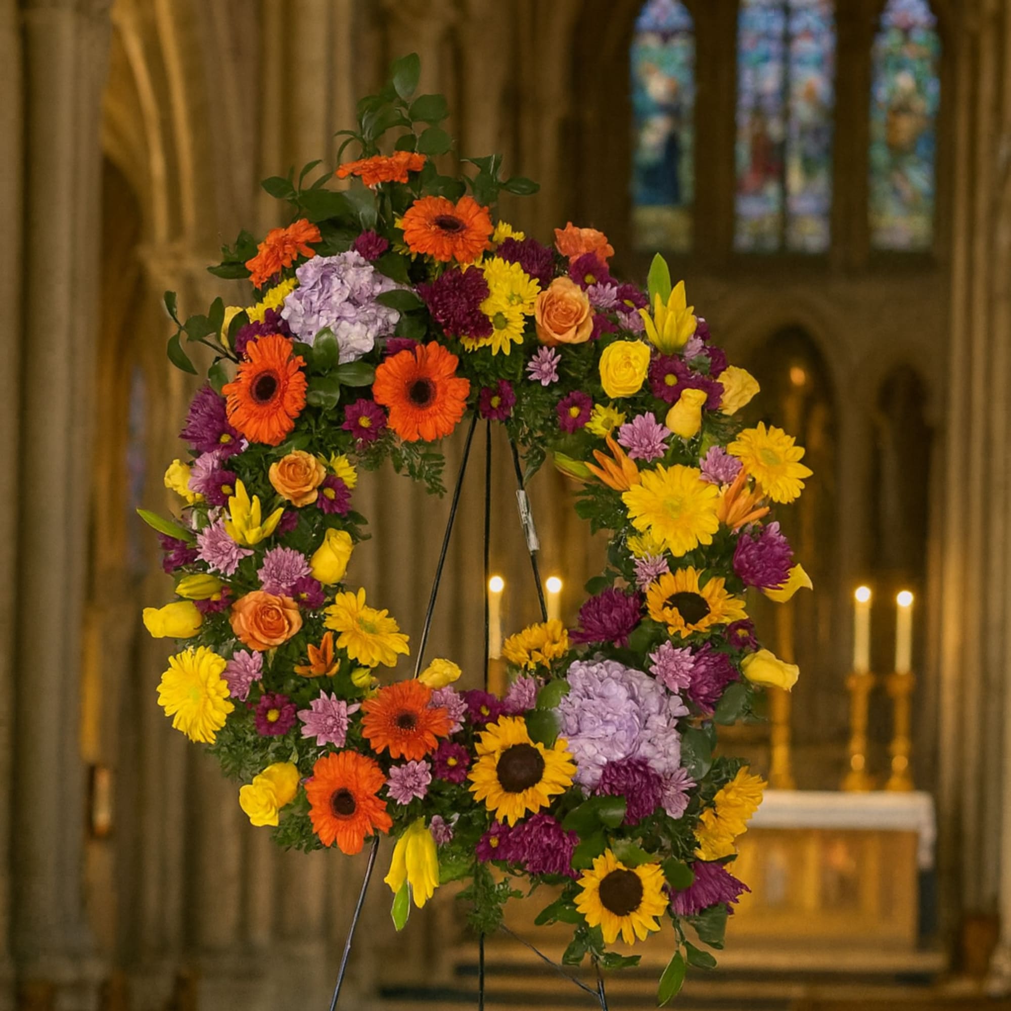 Colorful floral wreath on a stand inside a church