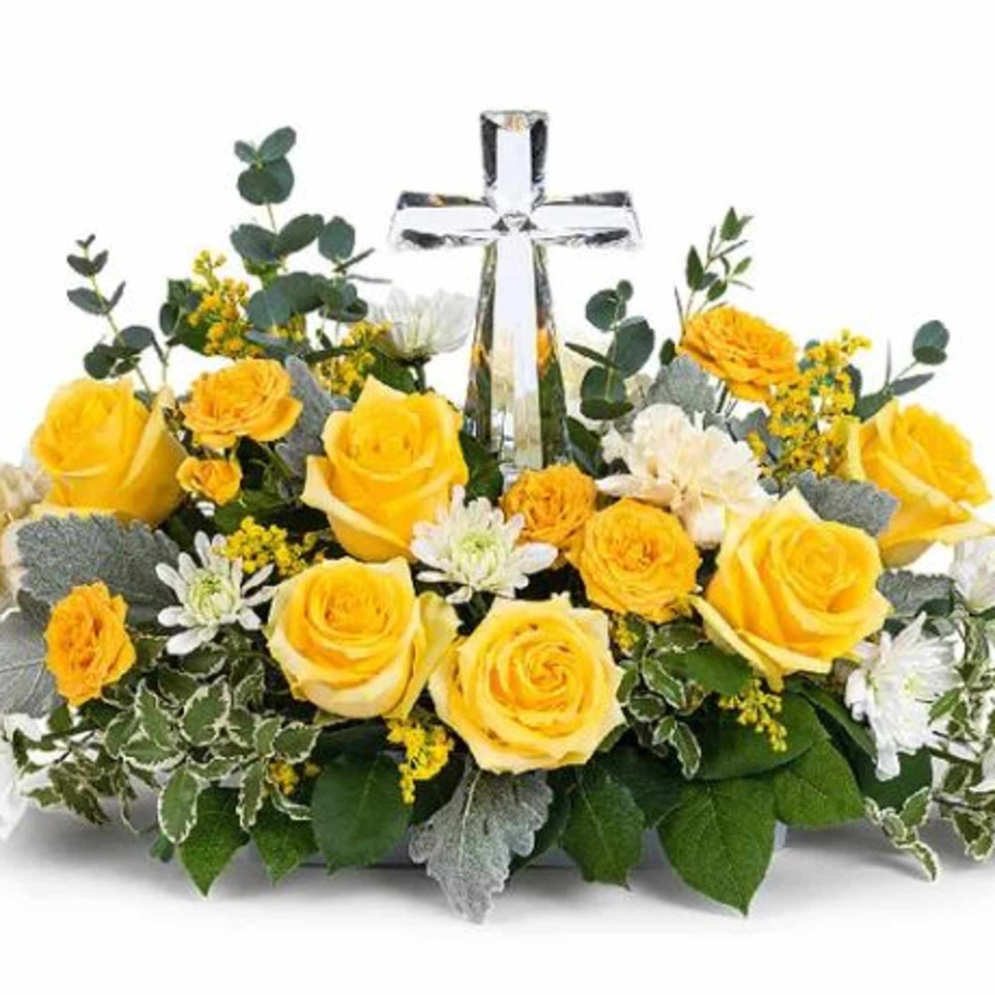 A crystal cross centerpiece is surrounded by the soft glow of yellow