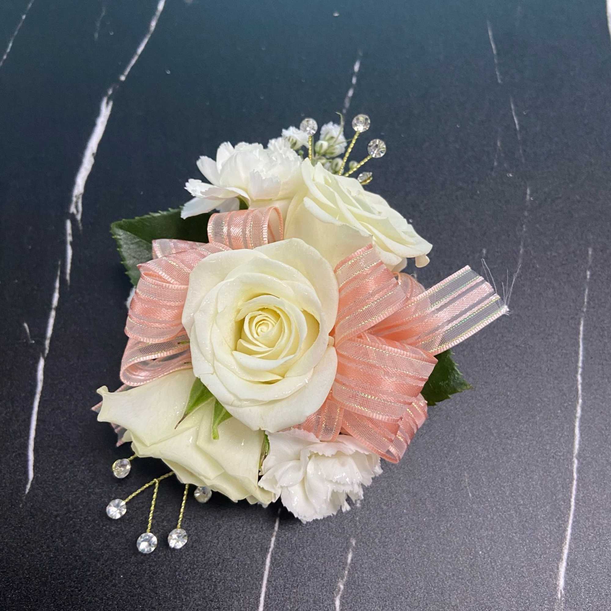 Small white rose corsage with pink ribbon and crystal accents