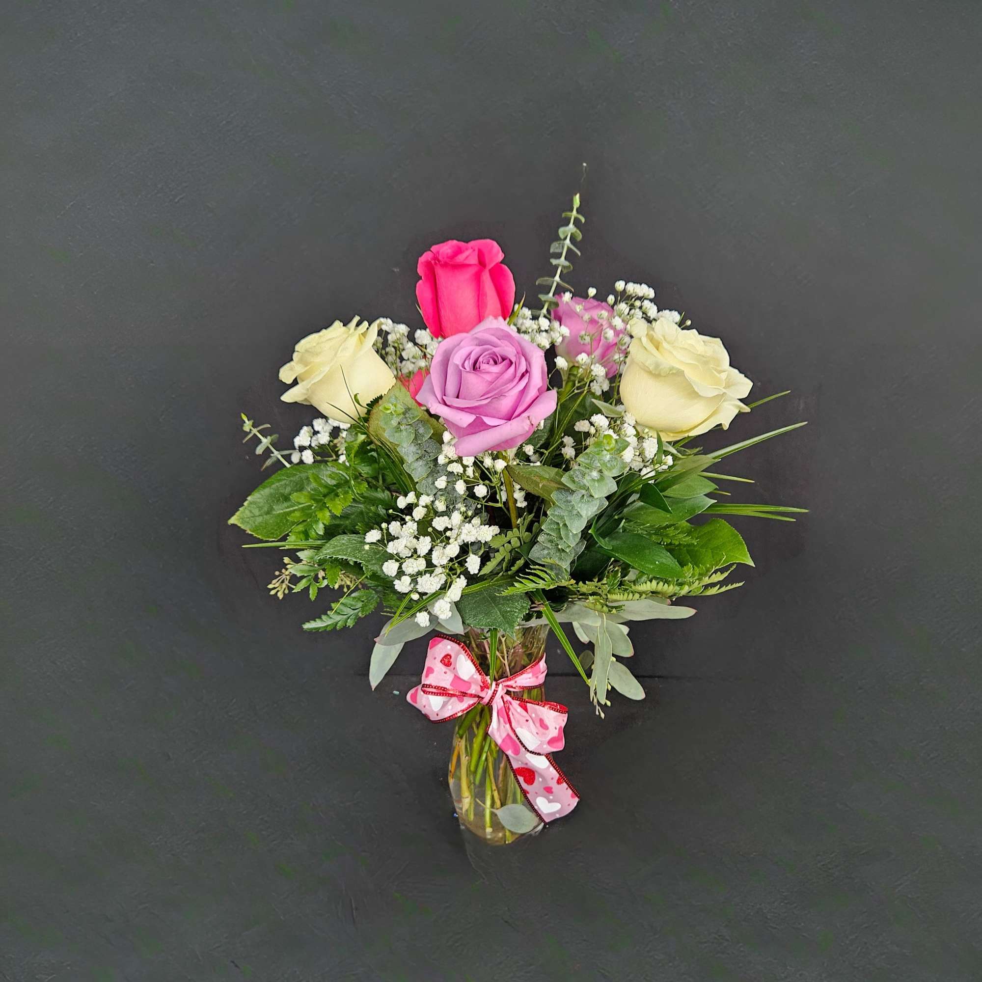 6 beautiful assorted color roses arranged in a vase with baby's breath, photo 3 of 3