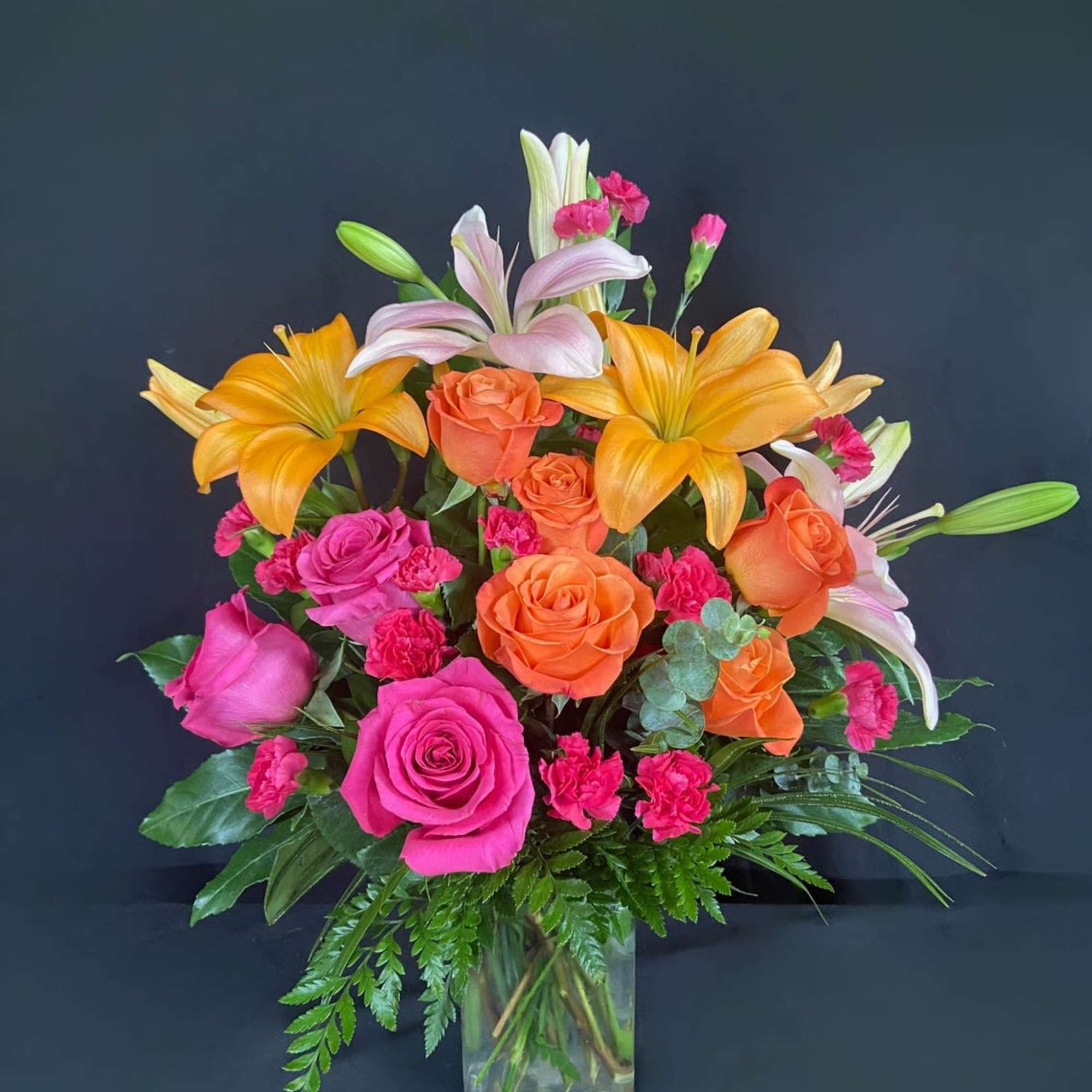 This arrangement is electric! Send this bright orange and hot pink rose