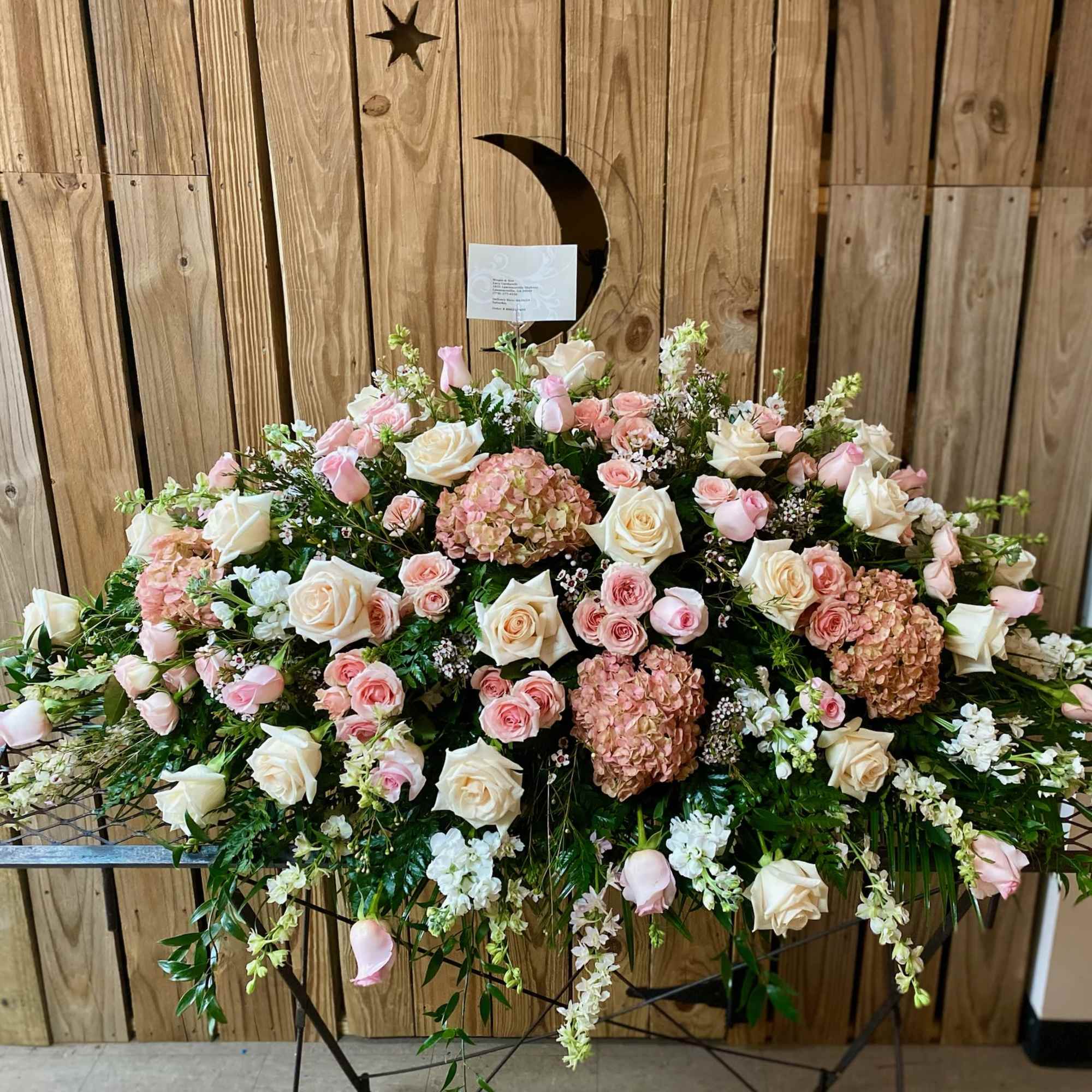 Large pink and white floral spray on a stand